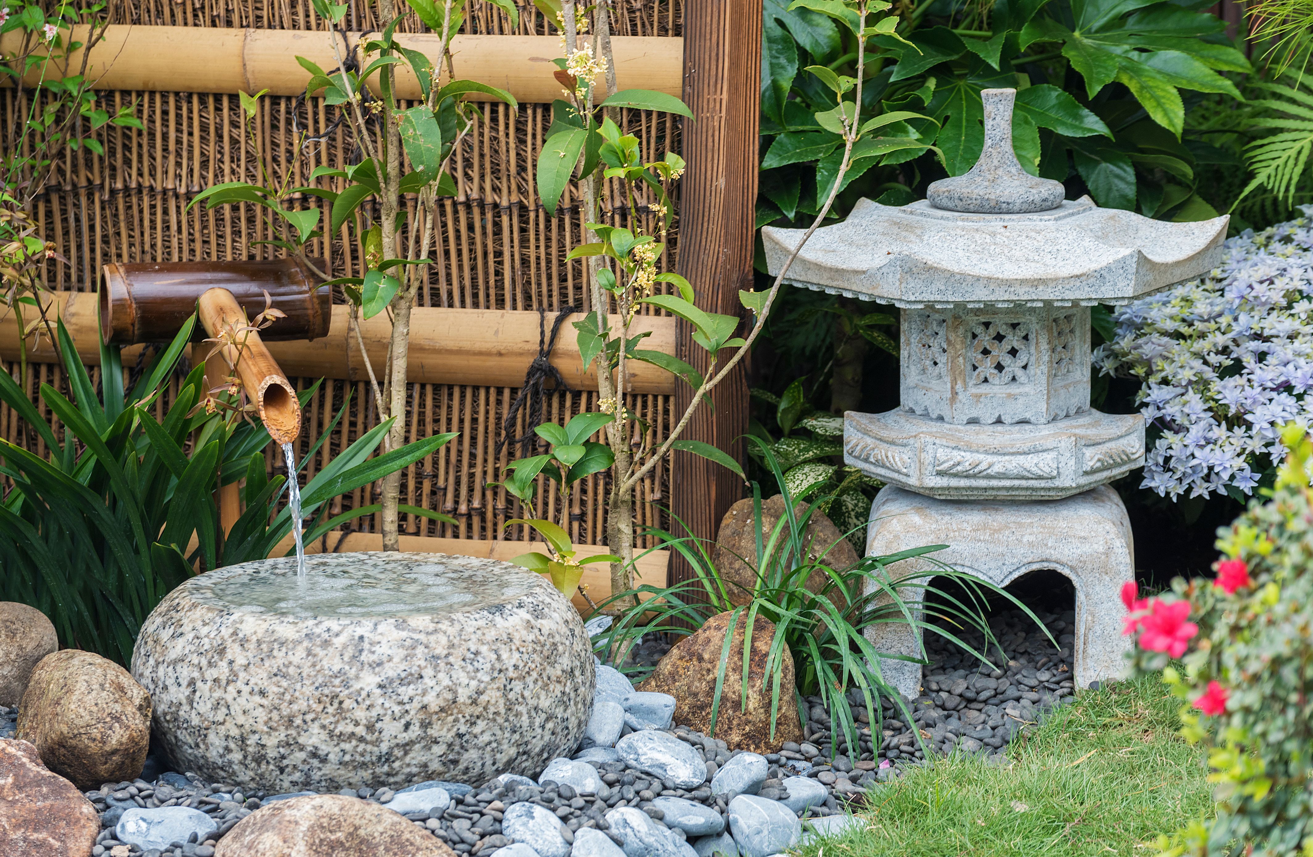 bamboo water feature next to a bamboo screen are a great zen garden ideas