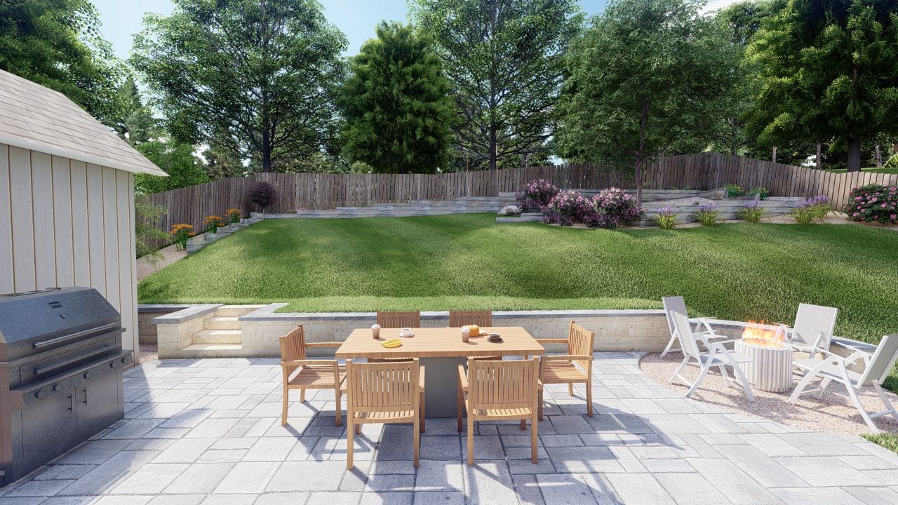 a sloped backyard with a stone patio and retaining wall, dining area and fire pit. A privacy fence in the back with colorful flowers in garden beds. 