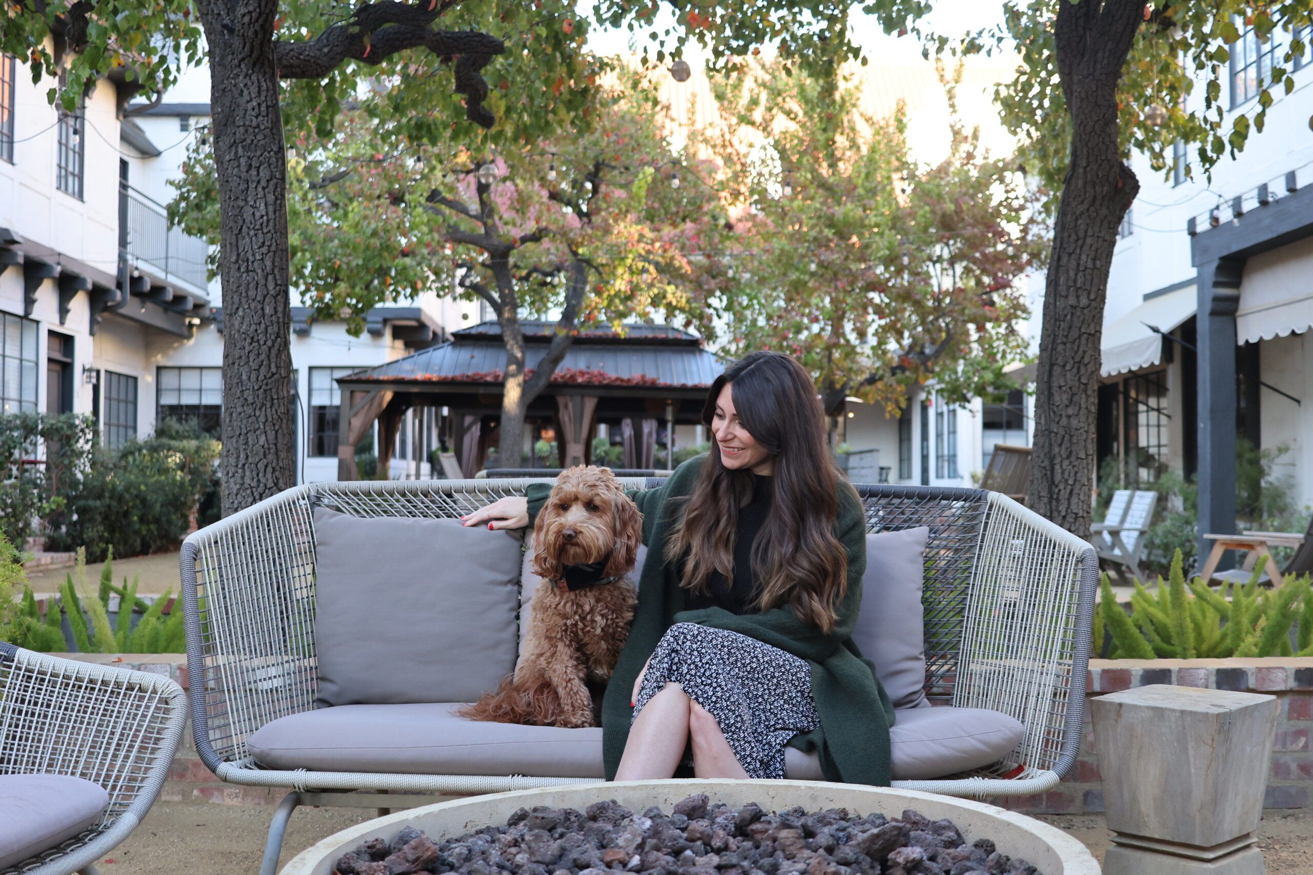 Melanie and her pup, Ruby outside on a bench