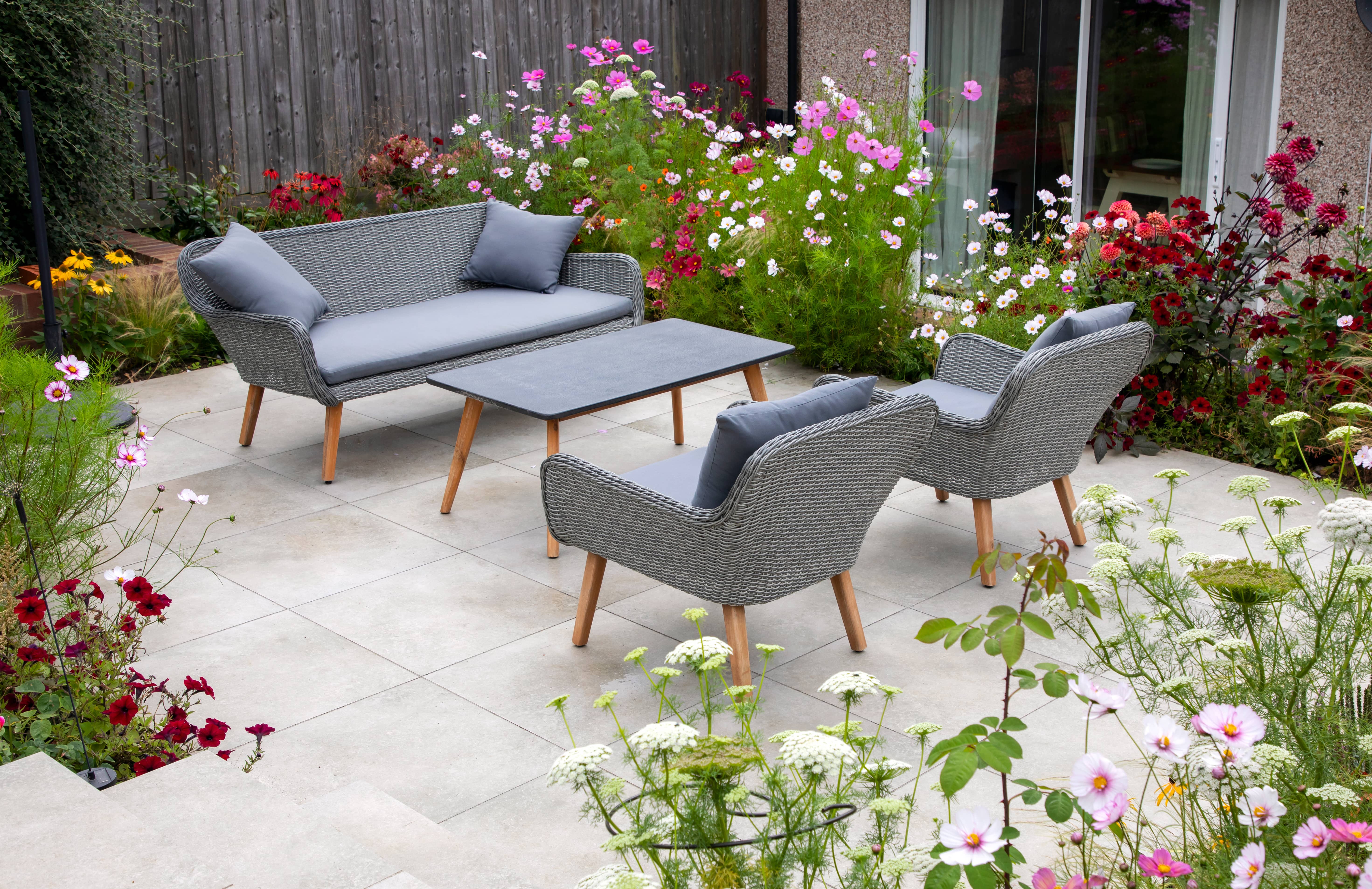 how to design a flower bed, flowering plants with the patio as the focal point 