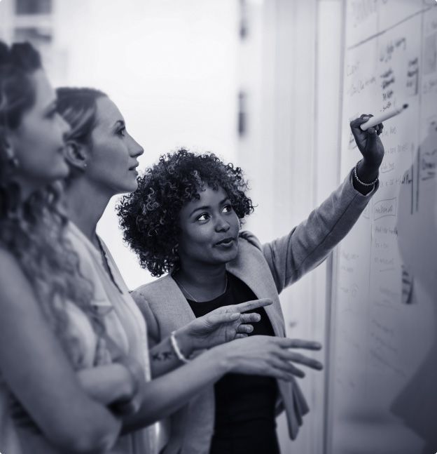 3 women reviewing meeting notes