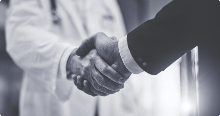 A sales rep and doctor shaking hands