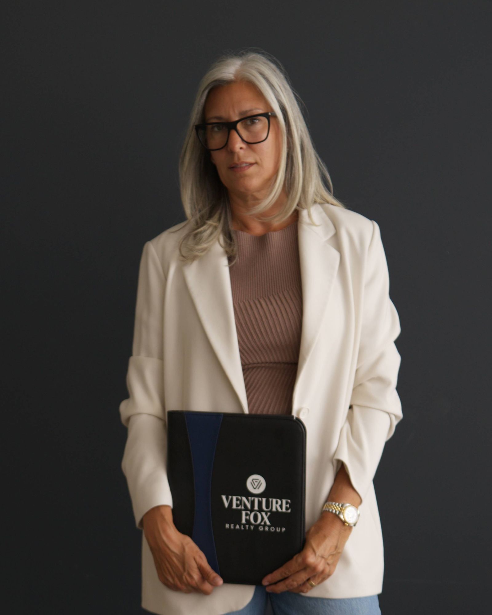 Jamie Mazuryk in glasses and a white blazer