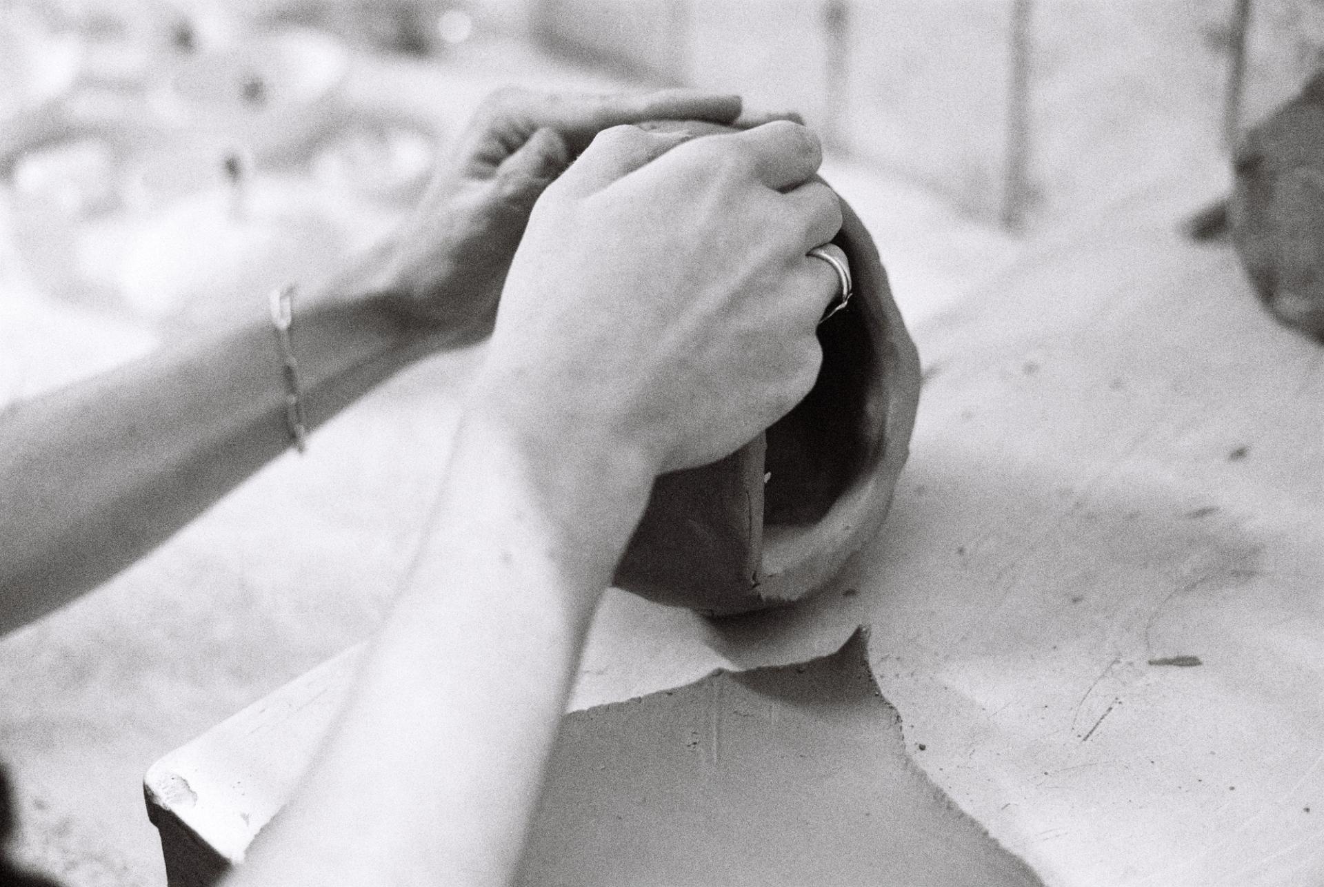 Close-up of hands working clay