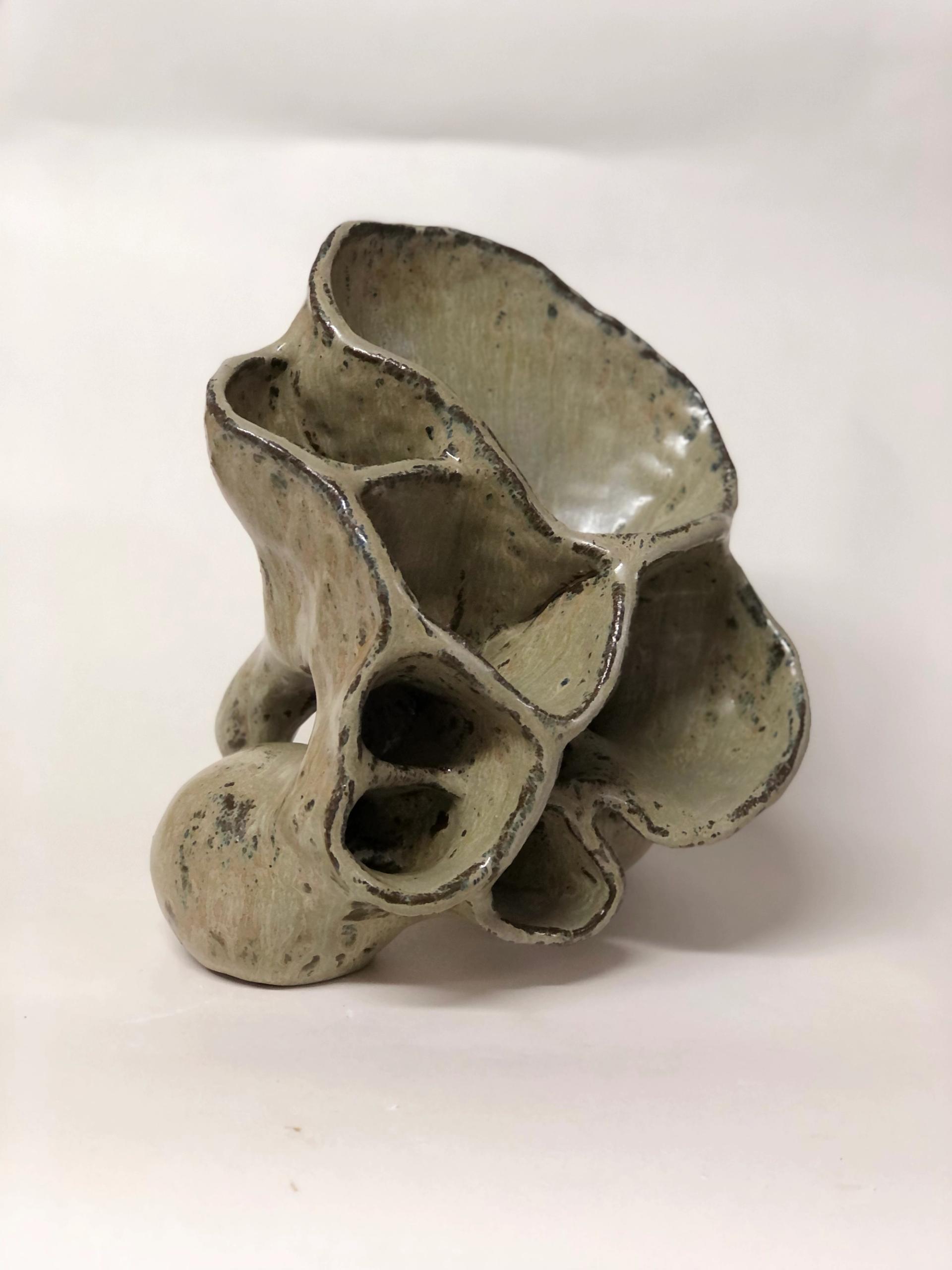 Sculptural ceramic piece with organic honeycomb form