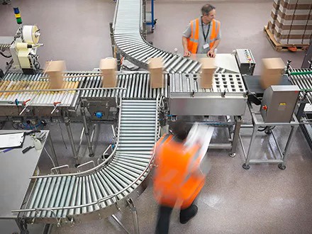 Someone managing the supply chain in a warehouse.