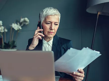 Executive looking over her organization's latest ESG disclosures.