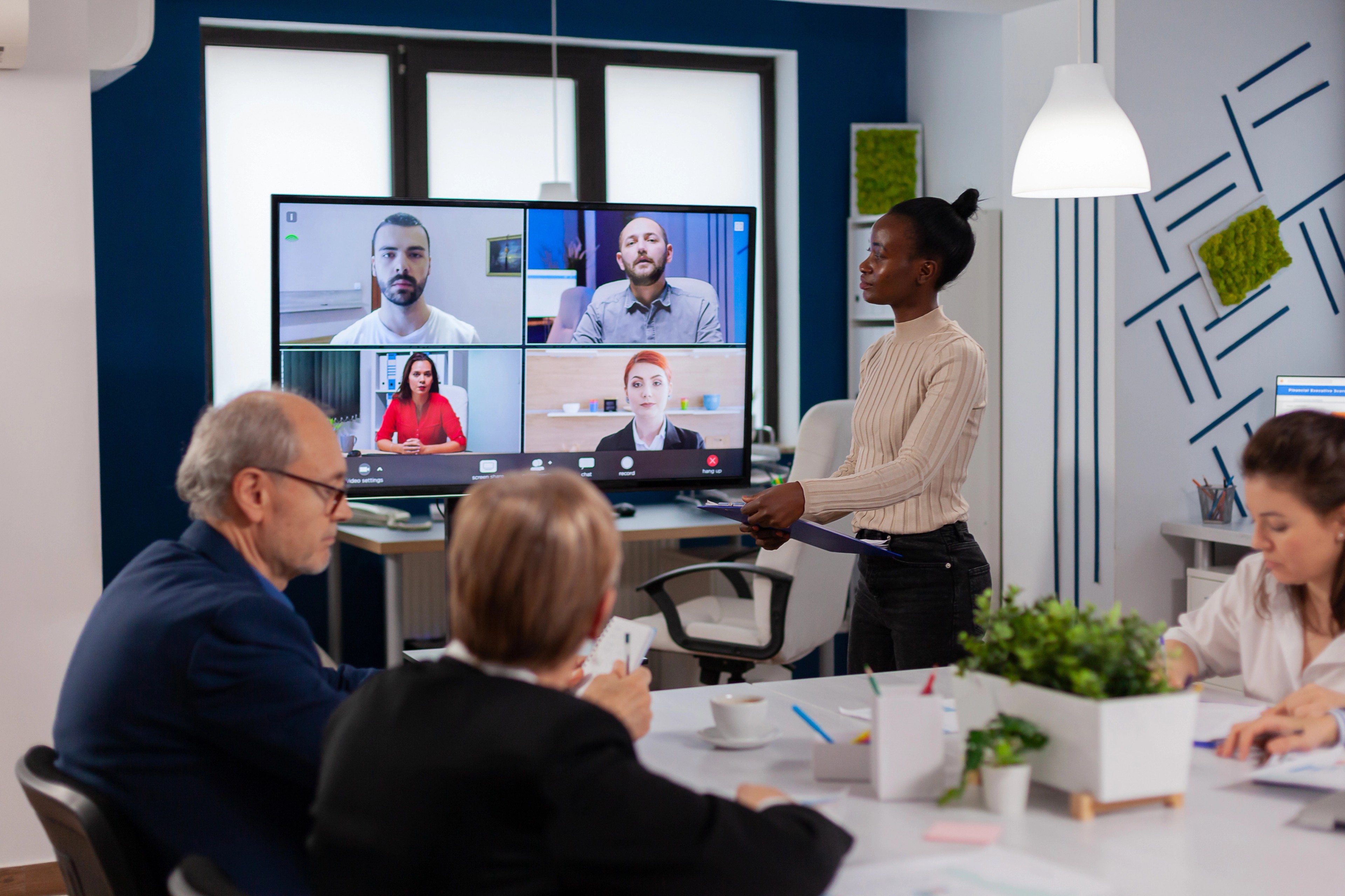 woman discussing with remote managers on video call presenting new partners on webcam