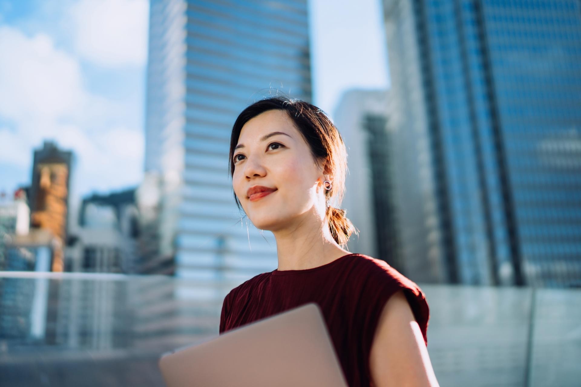 lady looking behind office buildings