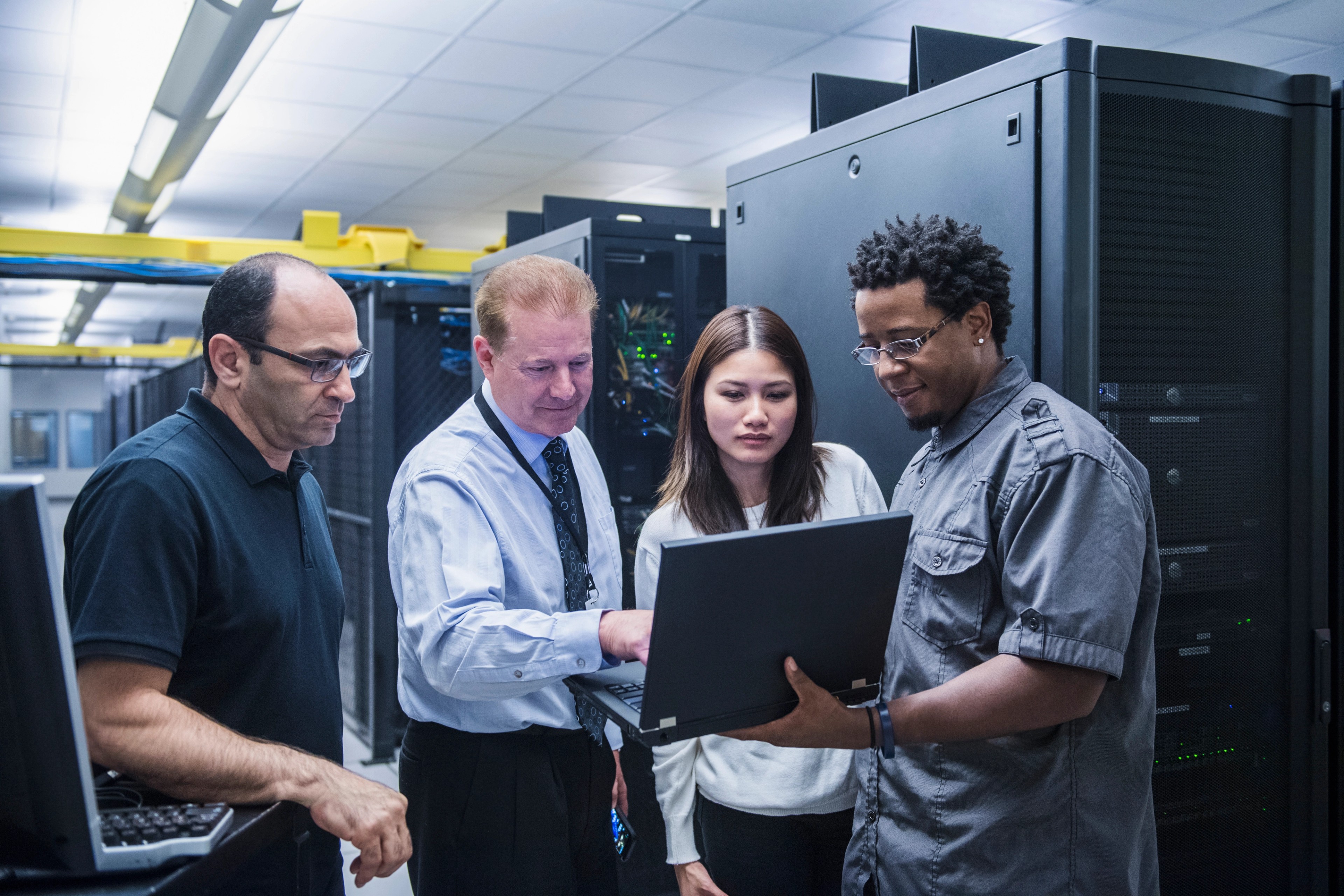 Colleagues working together in server room