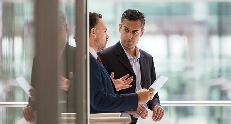 internal auditor and first-line control owner discussing control assessments