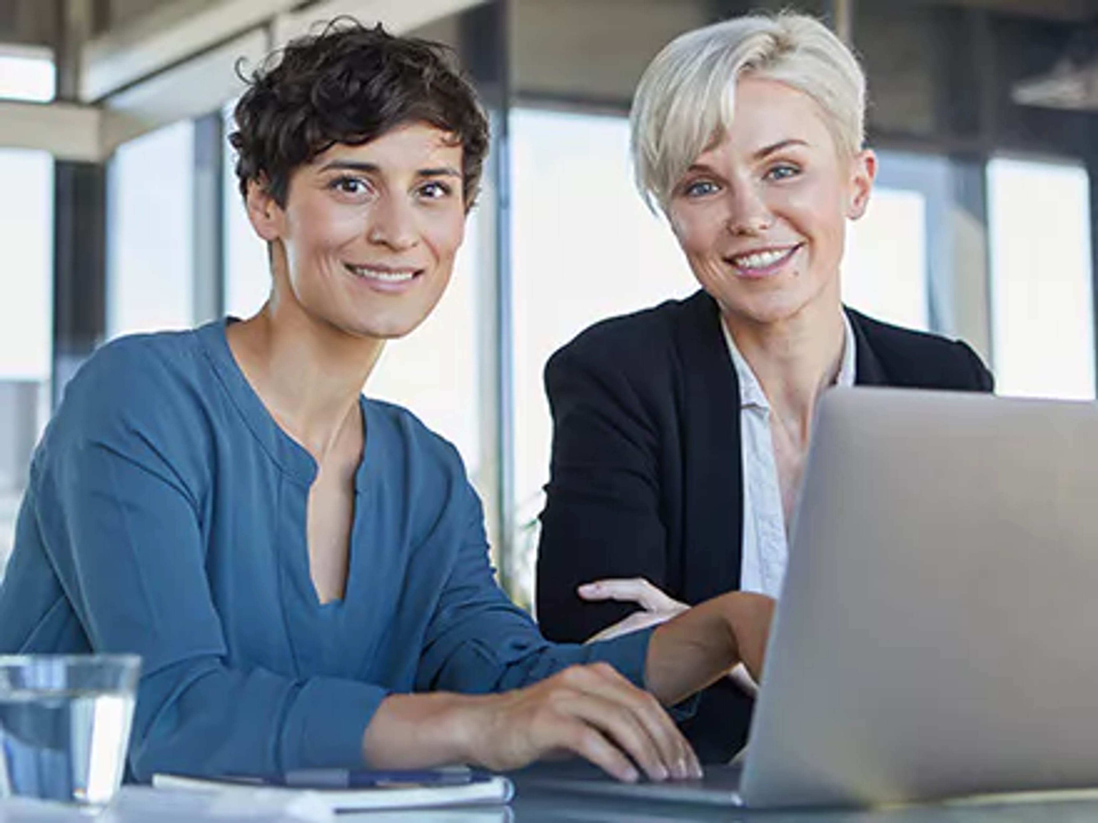 LGBTQ+ board members sitting at laptop, discussing the lavender ceiling