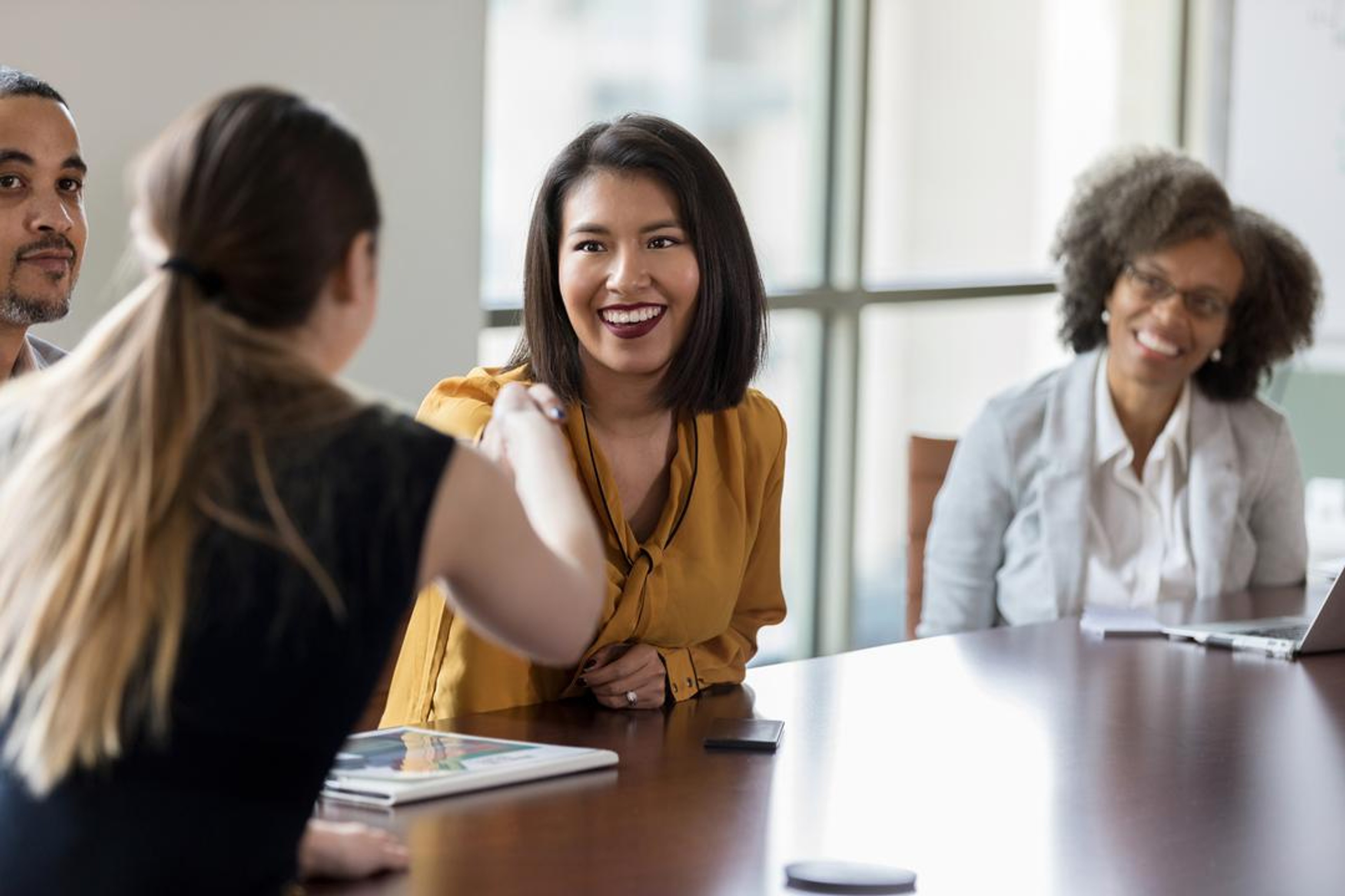 members of a board committee discussing the meeting agenda
