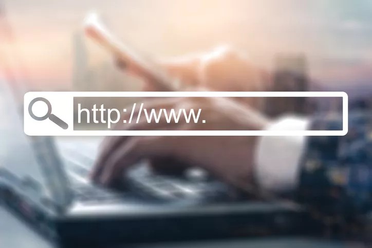 A professional typing on a laptop signifying the importance of an effective government website.