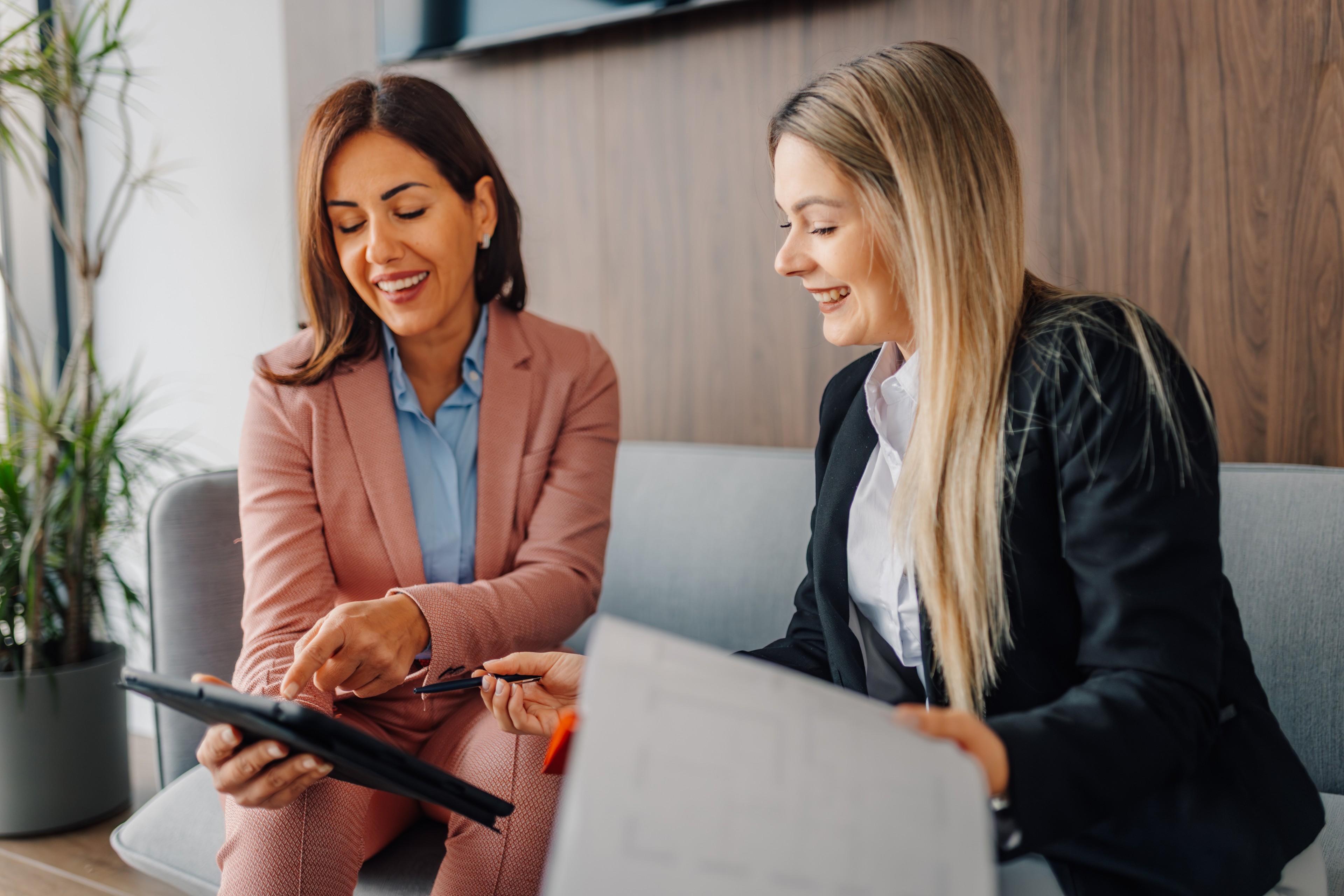 Two business women checking Diligent software dashboard