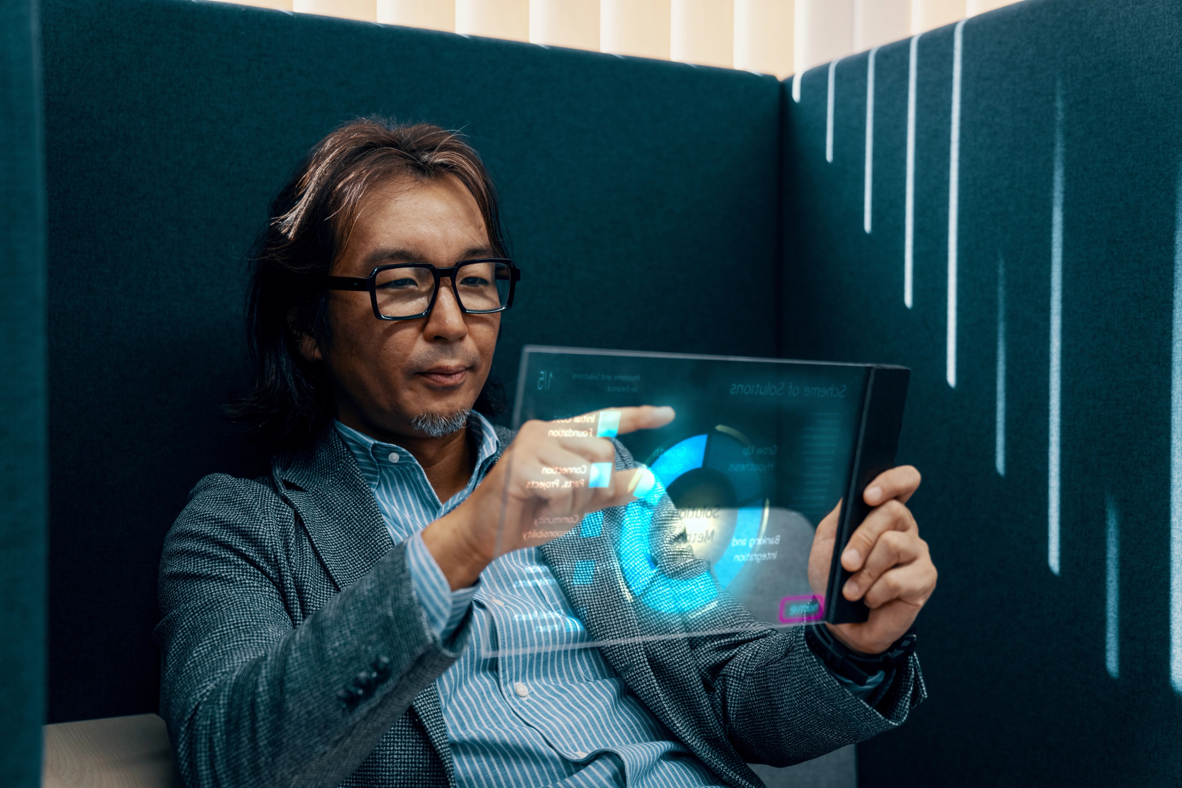 Mid adult businessman using futuristic AI tablet computer