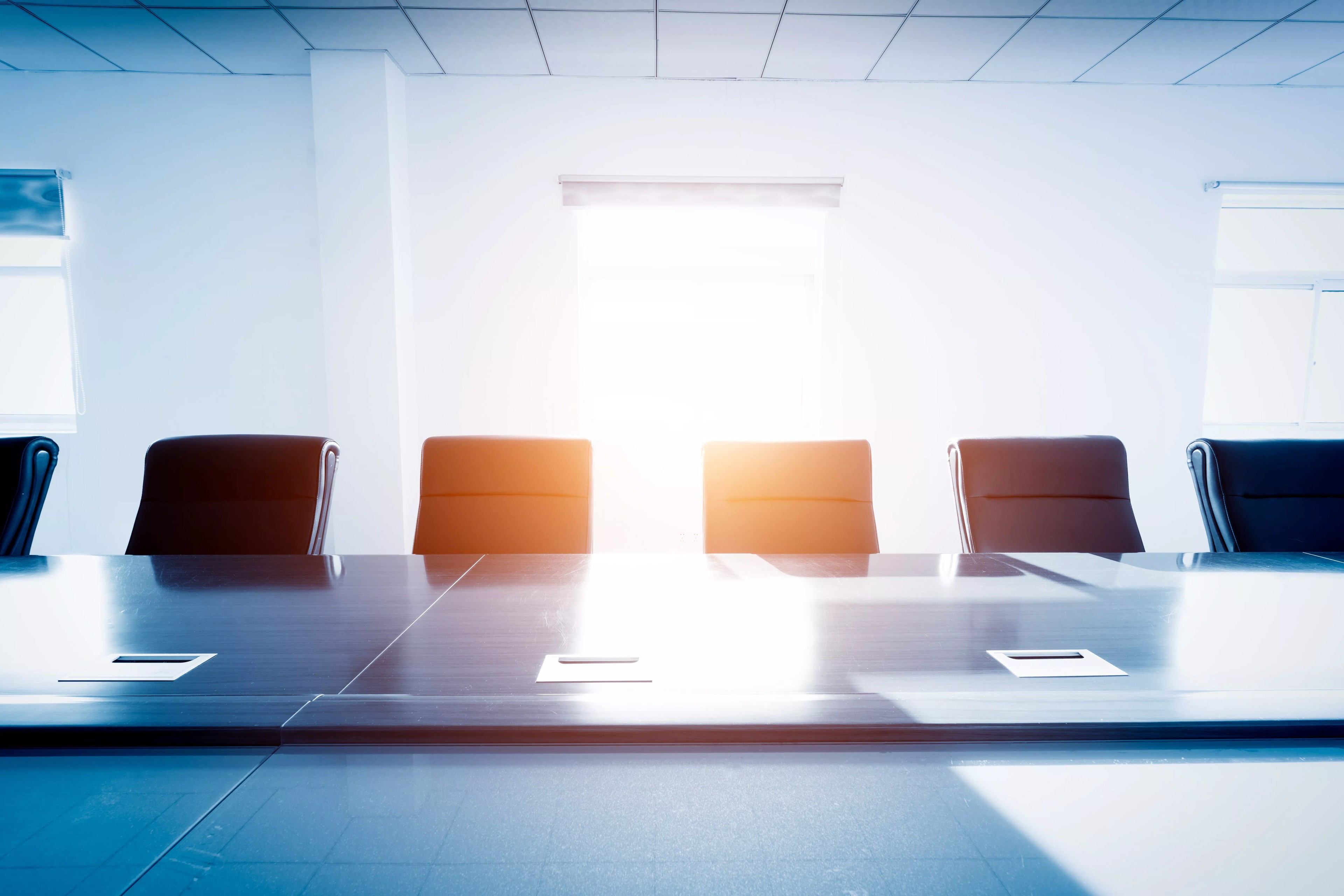 Boardroom with open seats to fill representing board composition