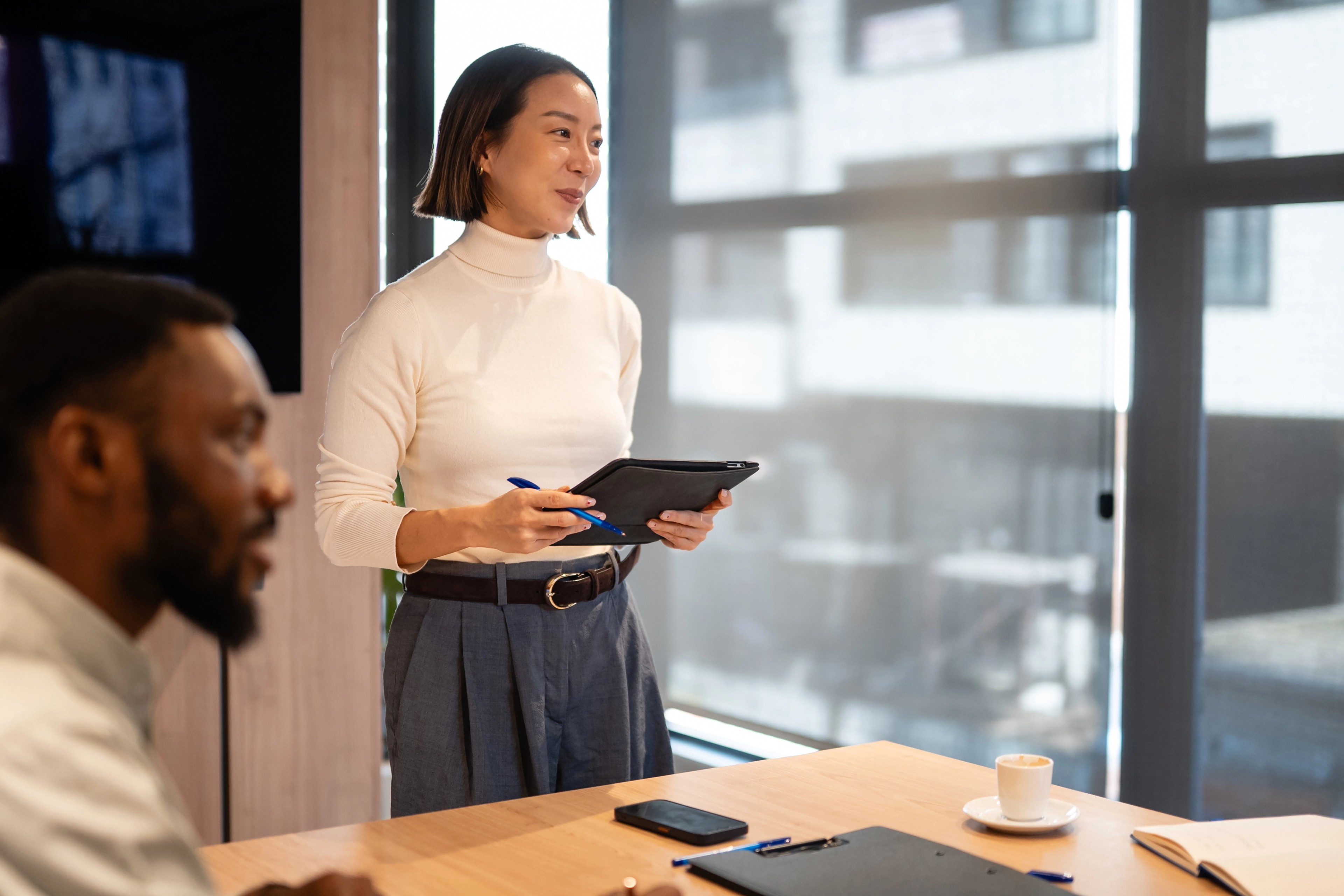 Woman using a digital AI interface, representing the shift from AI adoption to board-level accountability.