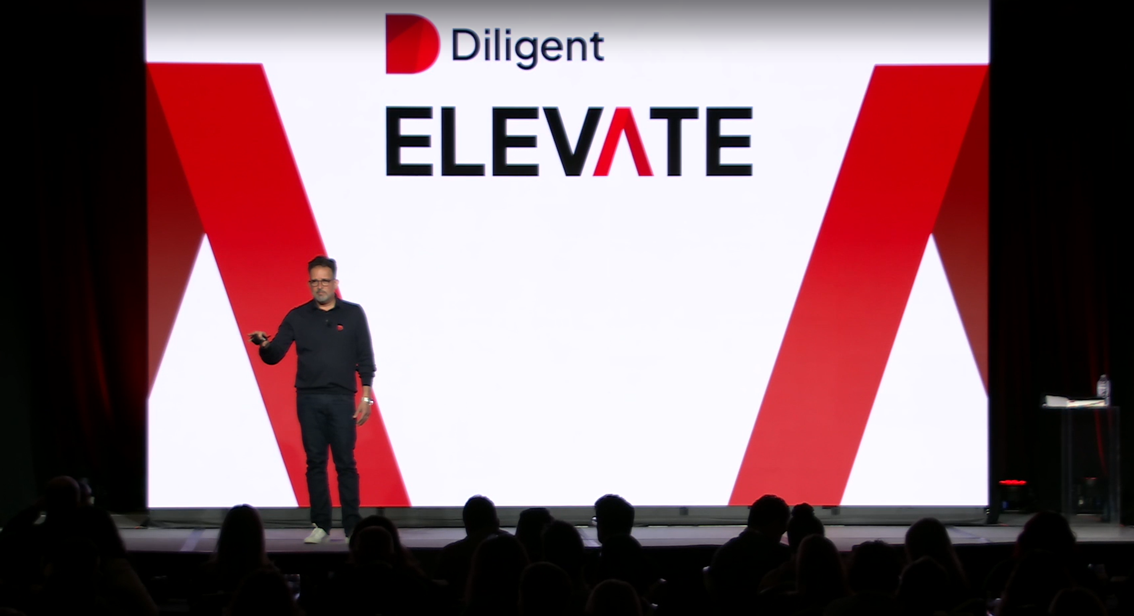 diligent ceo brian stafford standing on stage