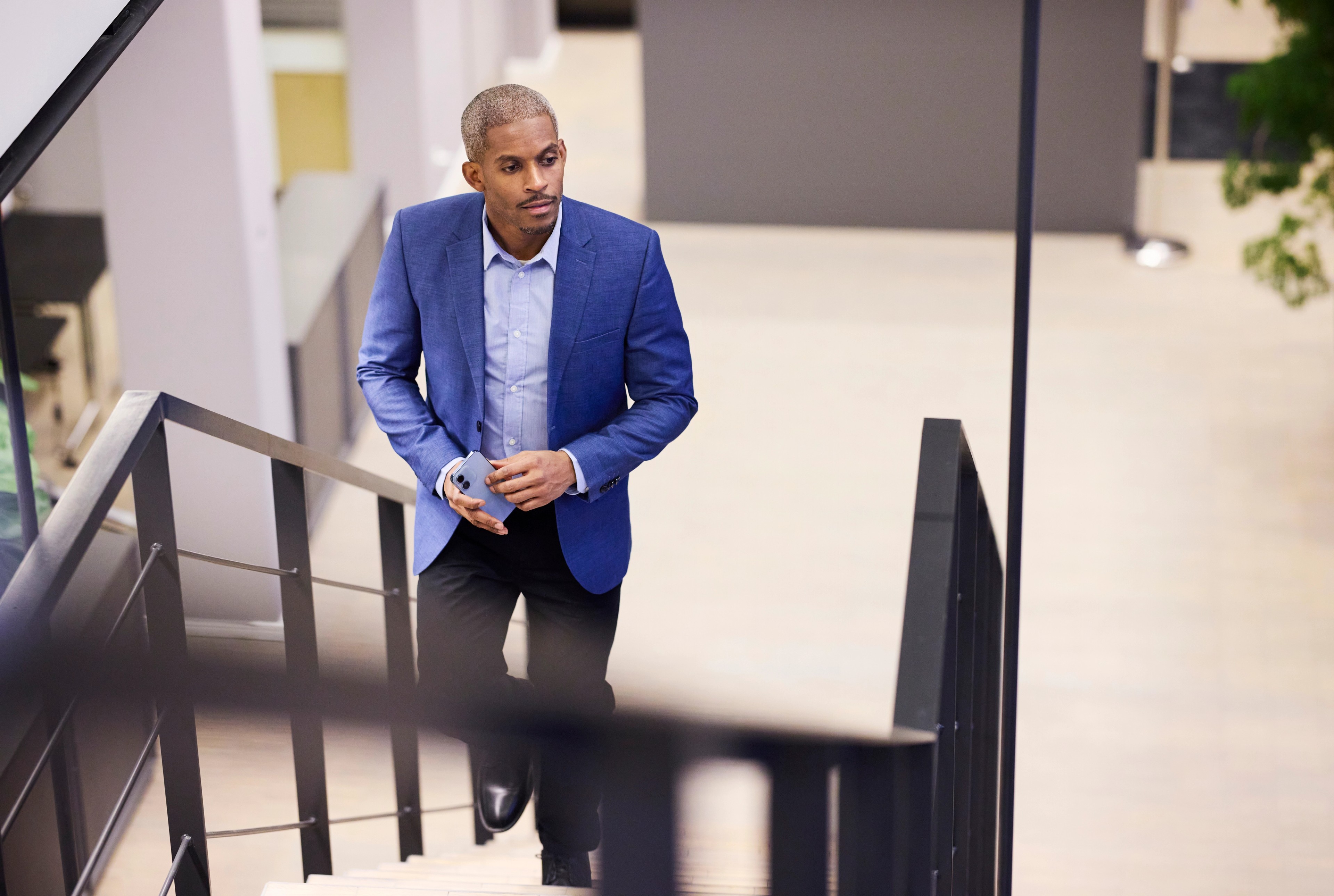 Businessman walking up office staircase
