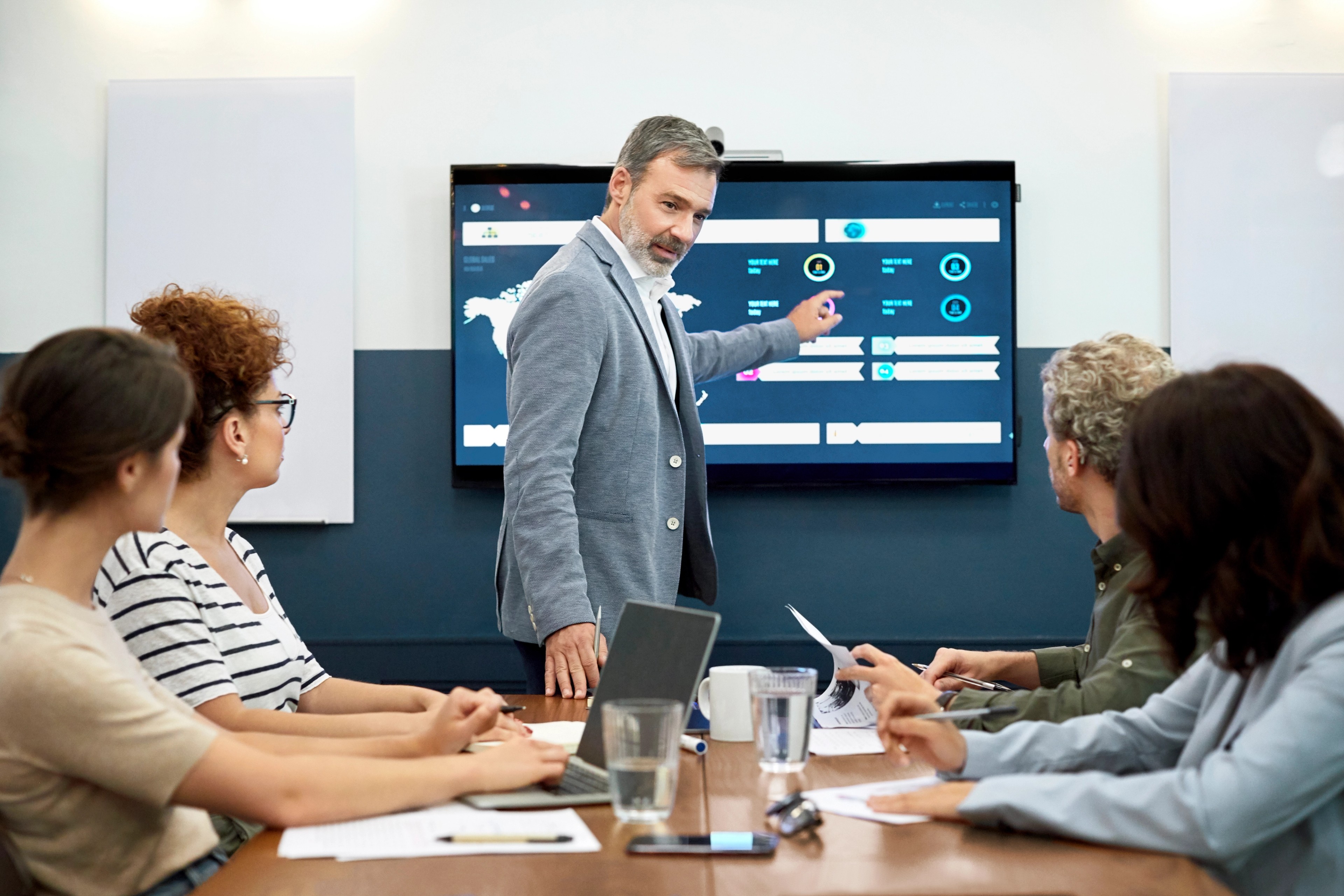 Businessman explaining infographic to partners