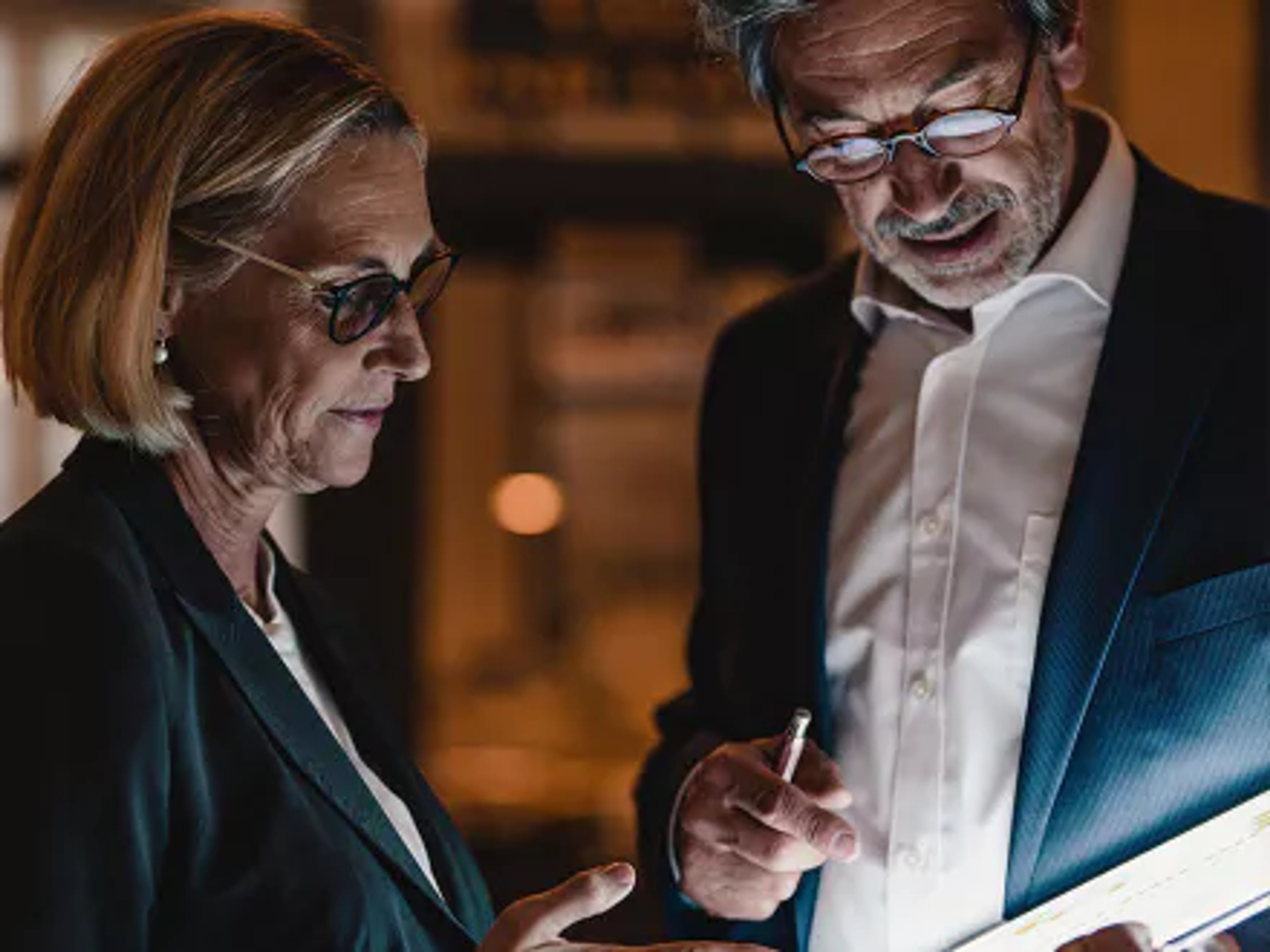 Two professionals assessing ESG risks for banks.