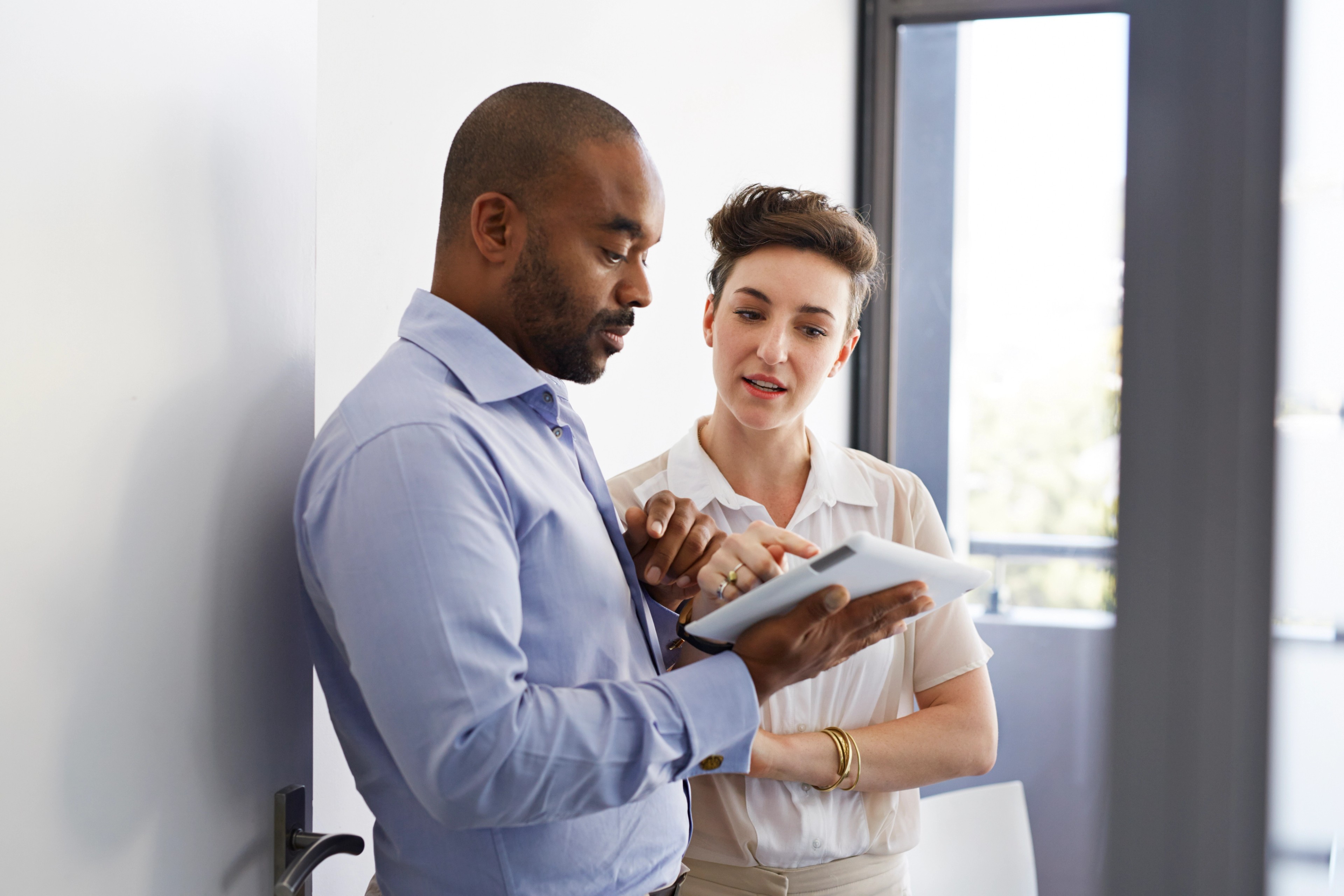 Two professionals discussing the Digital Operational Resilience Act (DORA)