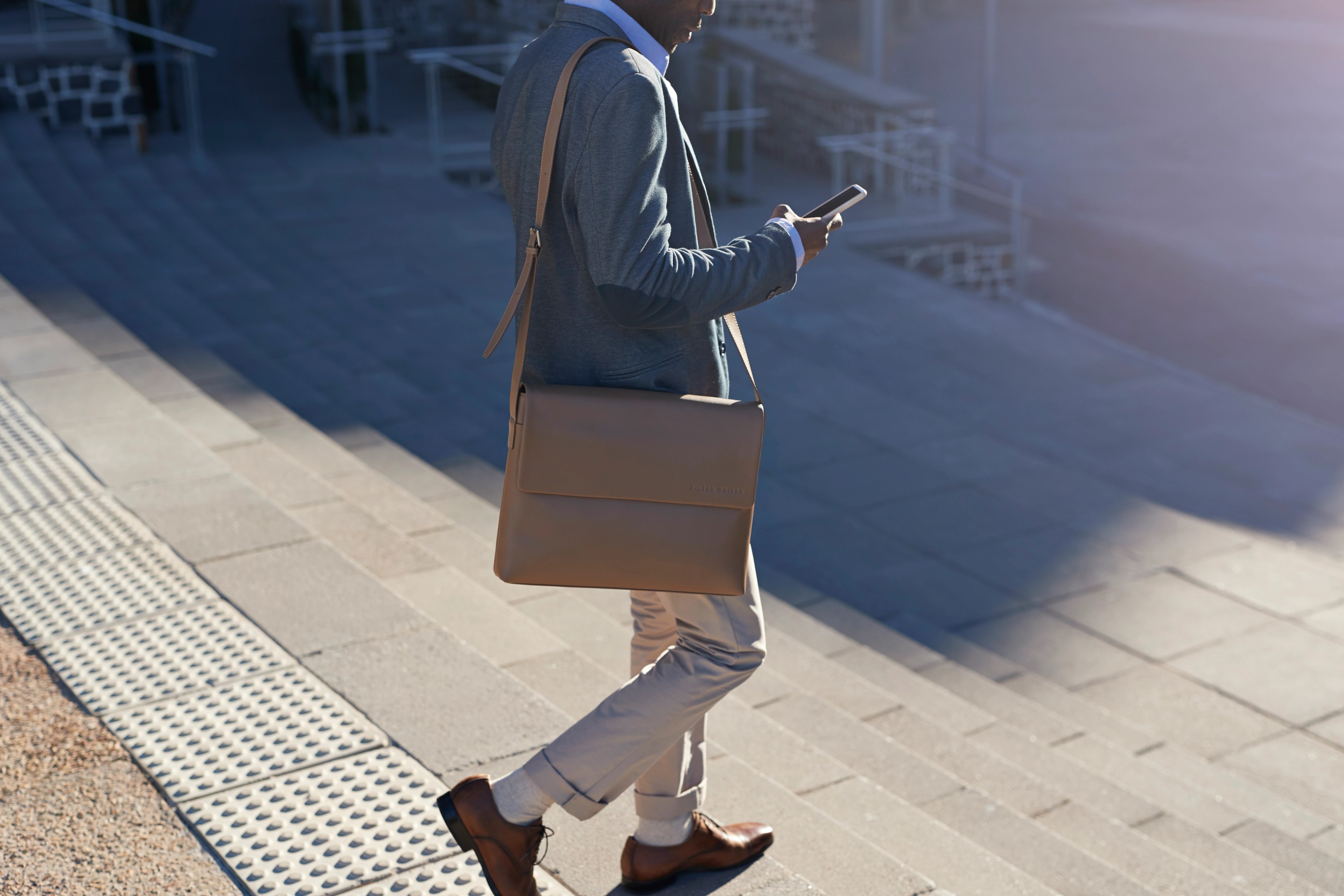 Businessman walking on staircase with bags