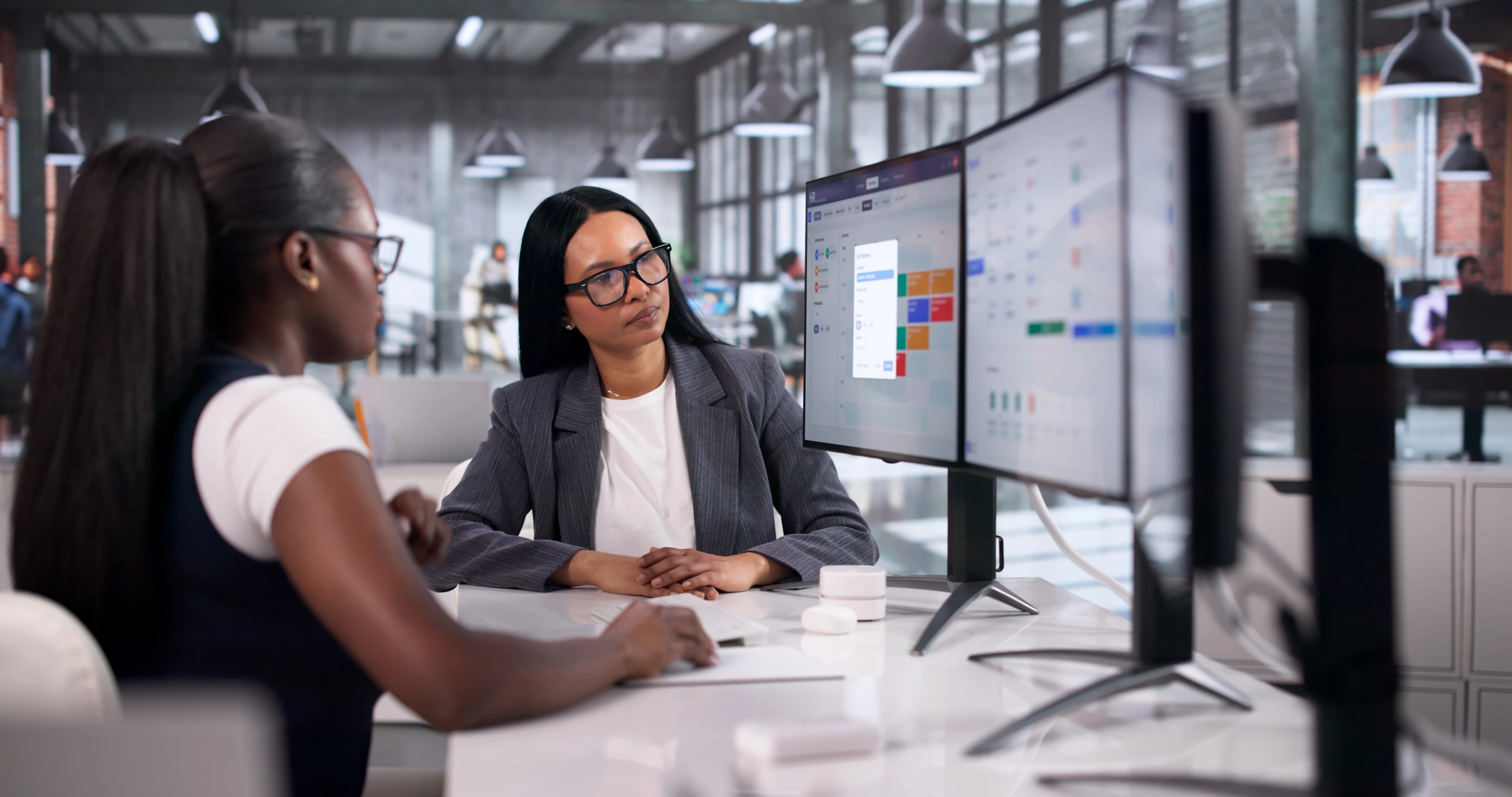 Human Resource Manager Explains Payroll Software To Two Women Colleagues