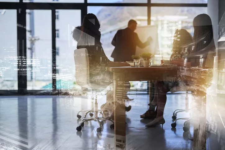The executive committee sitting at table.