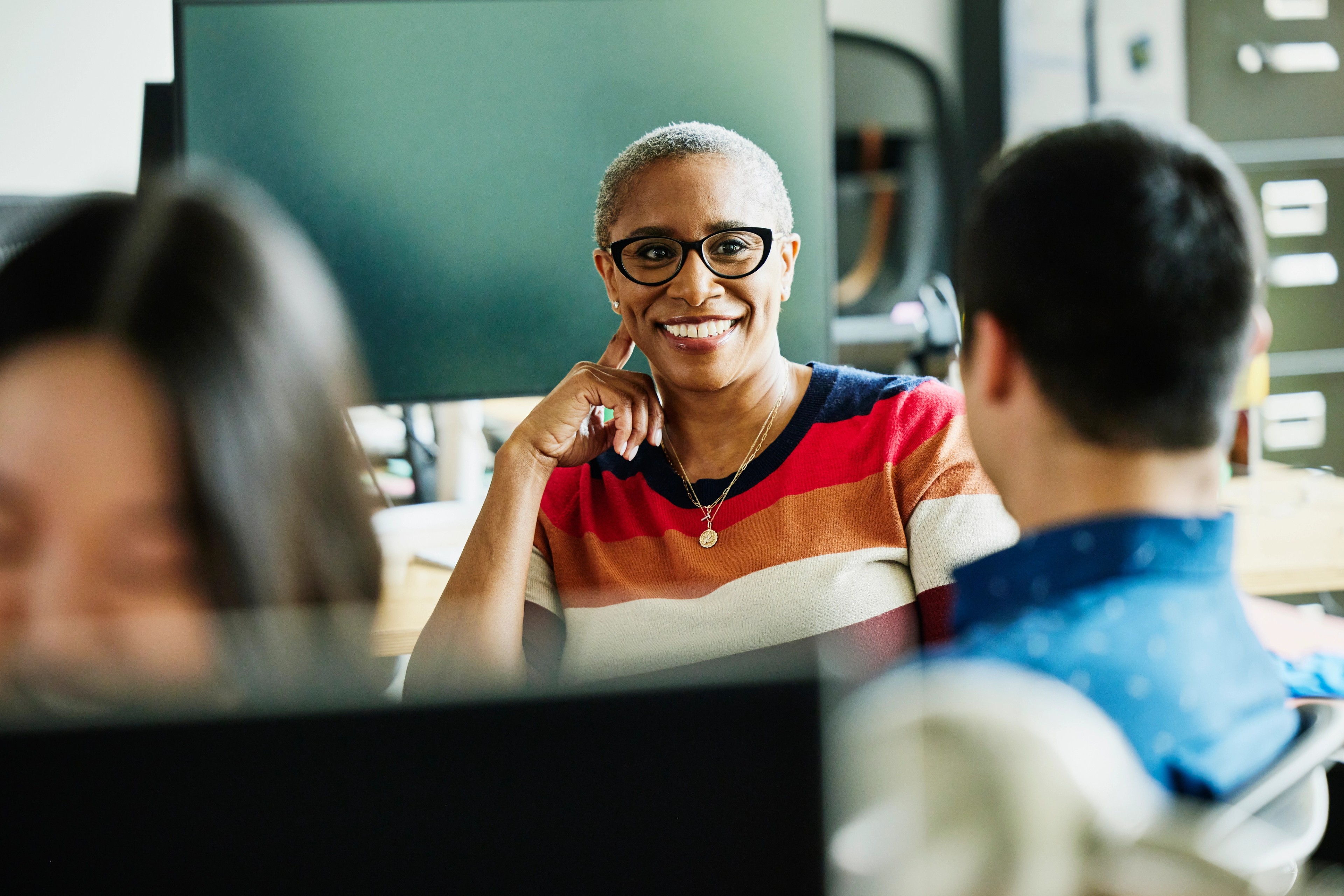 Professional reviewing compliance training courses in Diligent Compliance Education on a laptop.