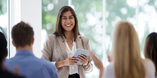 professional-woman-smiling-with-notepad