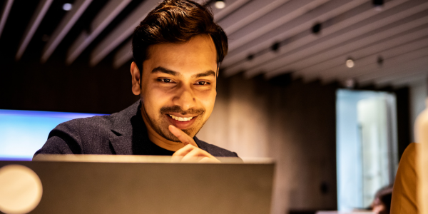 man looks at laptop
