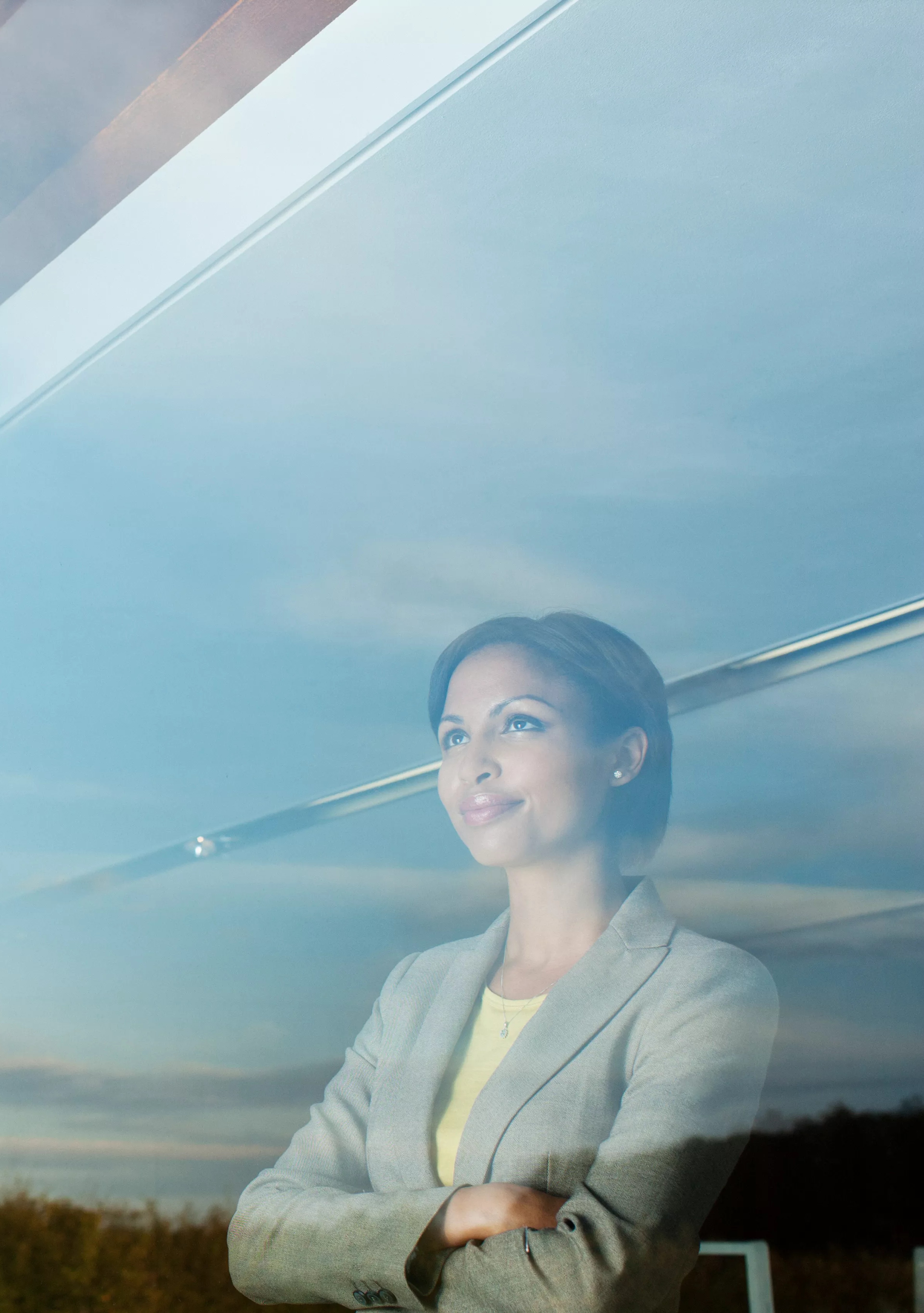 Woman staring out of an office building window