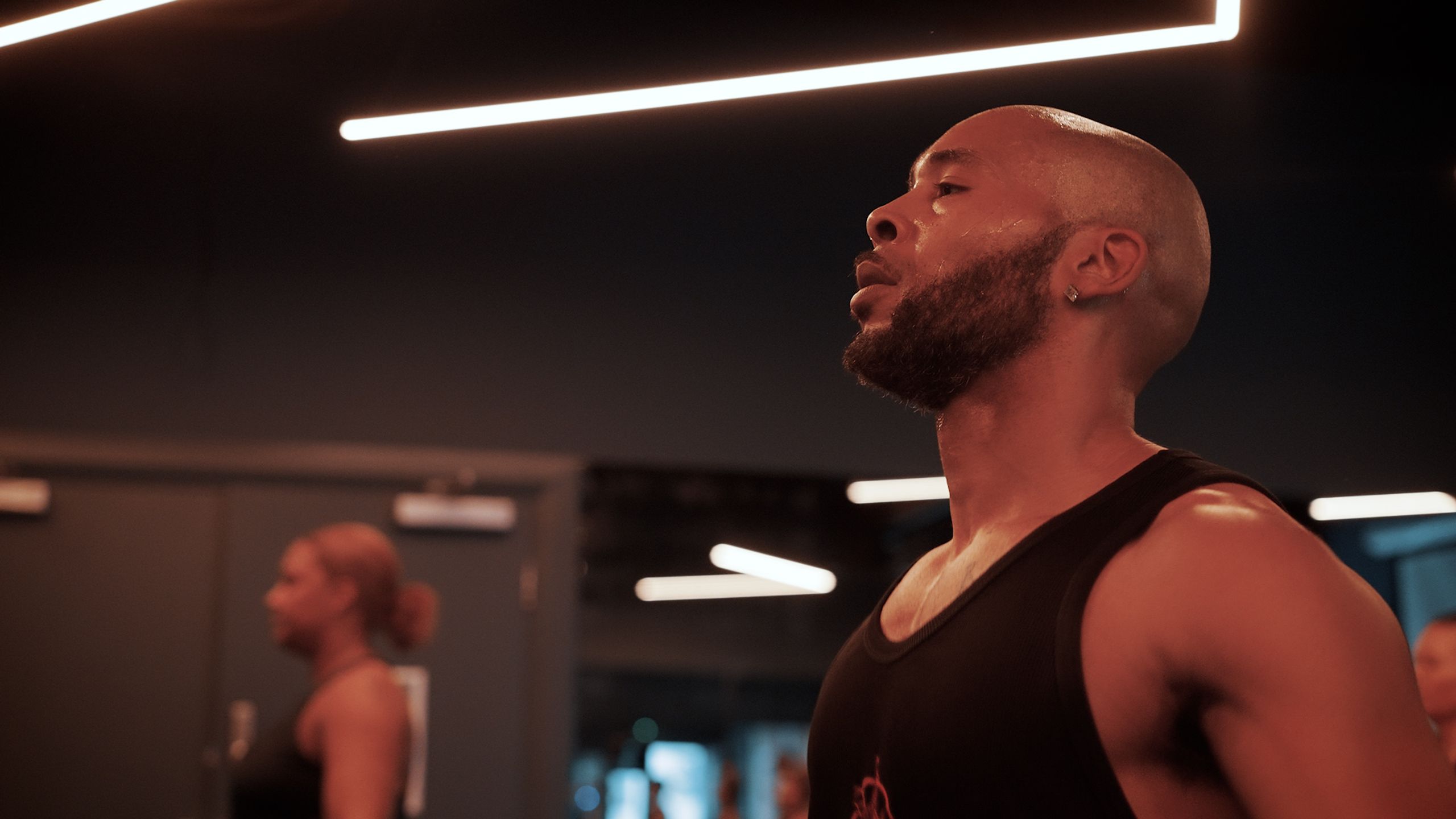 A member catching their breath between rounds in the studio at Fit This