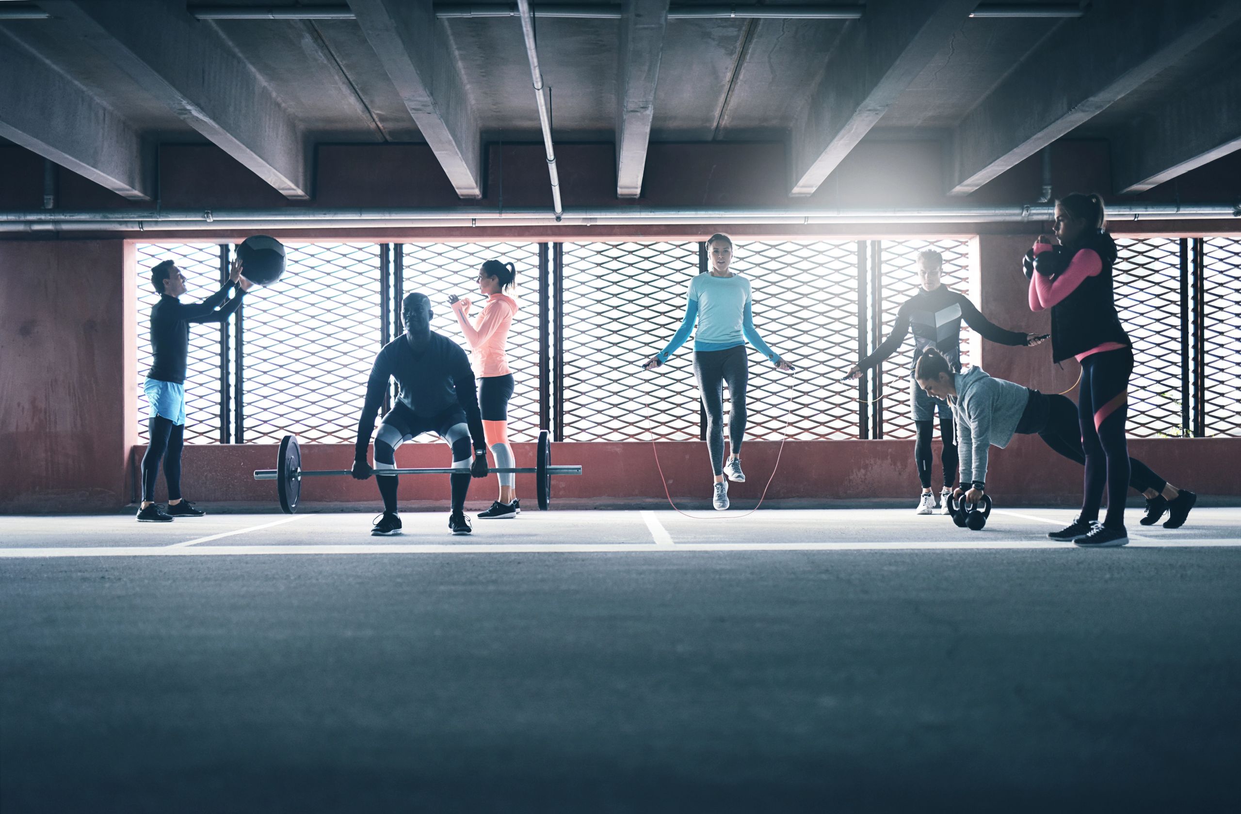A group workout with skipping ropes, barbells and medicine balls