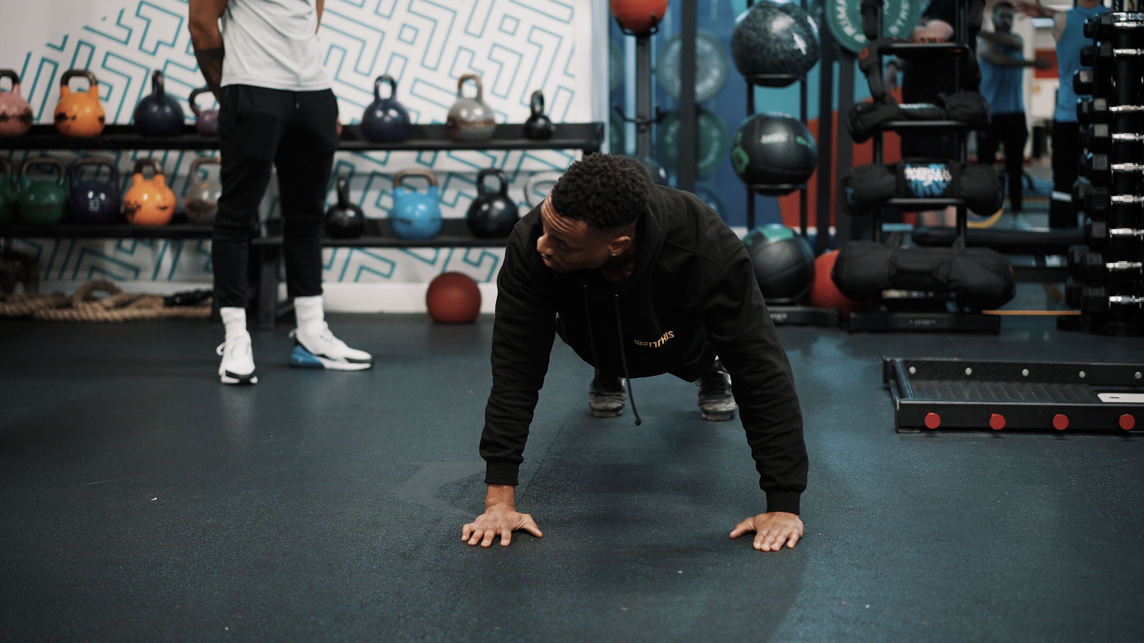 A member doing press-ups on the gym floor at Fit This