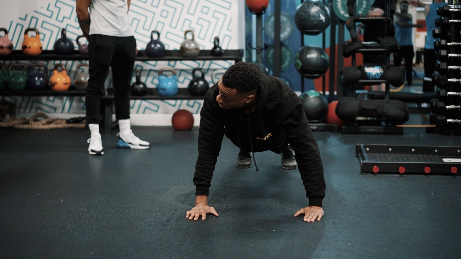 Personal trainer giving push up class