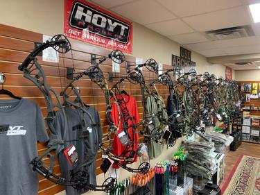 Compound bows hanging on slatwall