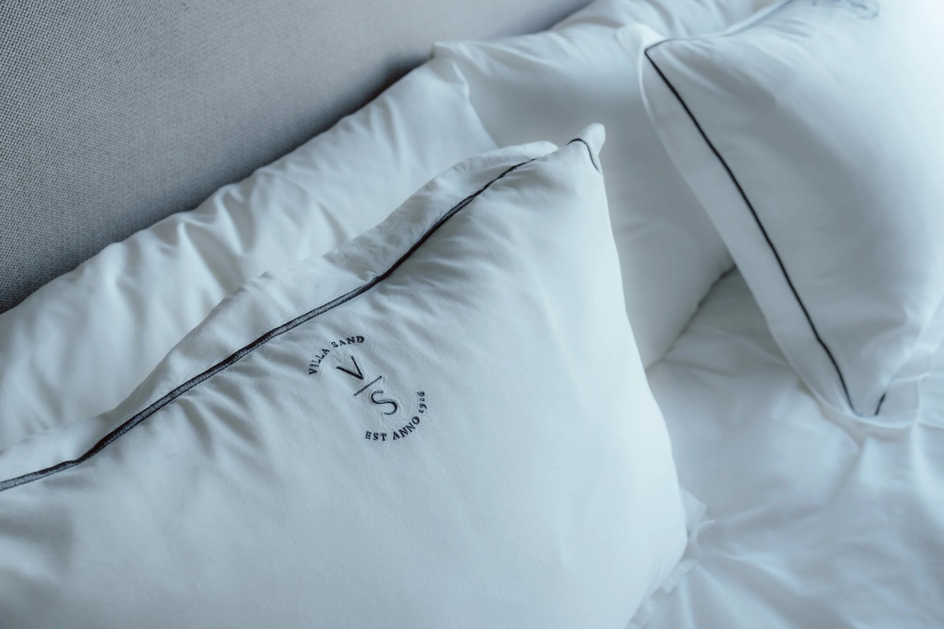 Villa Sand monogram on white bed linen