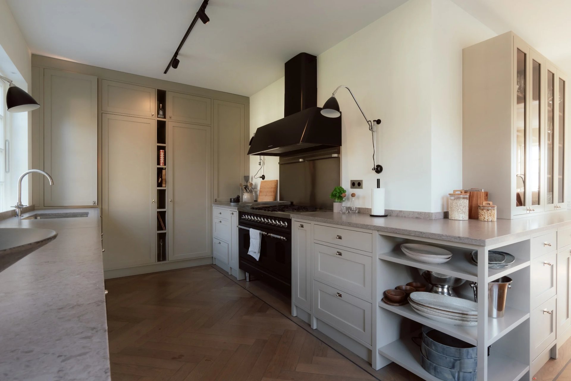Villa Sand’s kitchen with pale cabinetry and a black range cooker