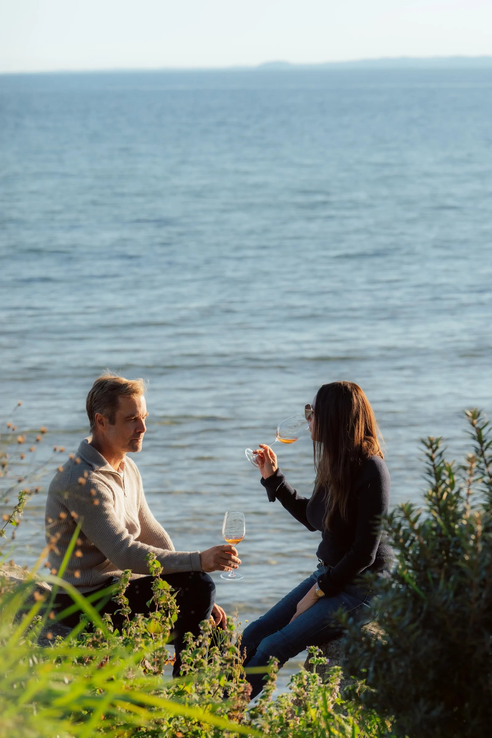Guests enjoying drinks beside the sea at Villa Sand