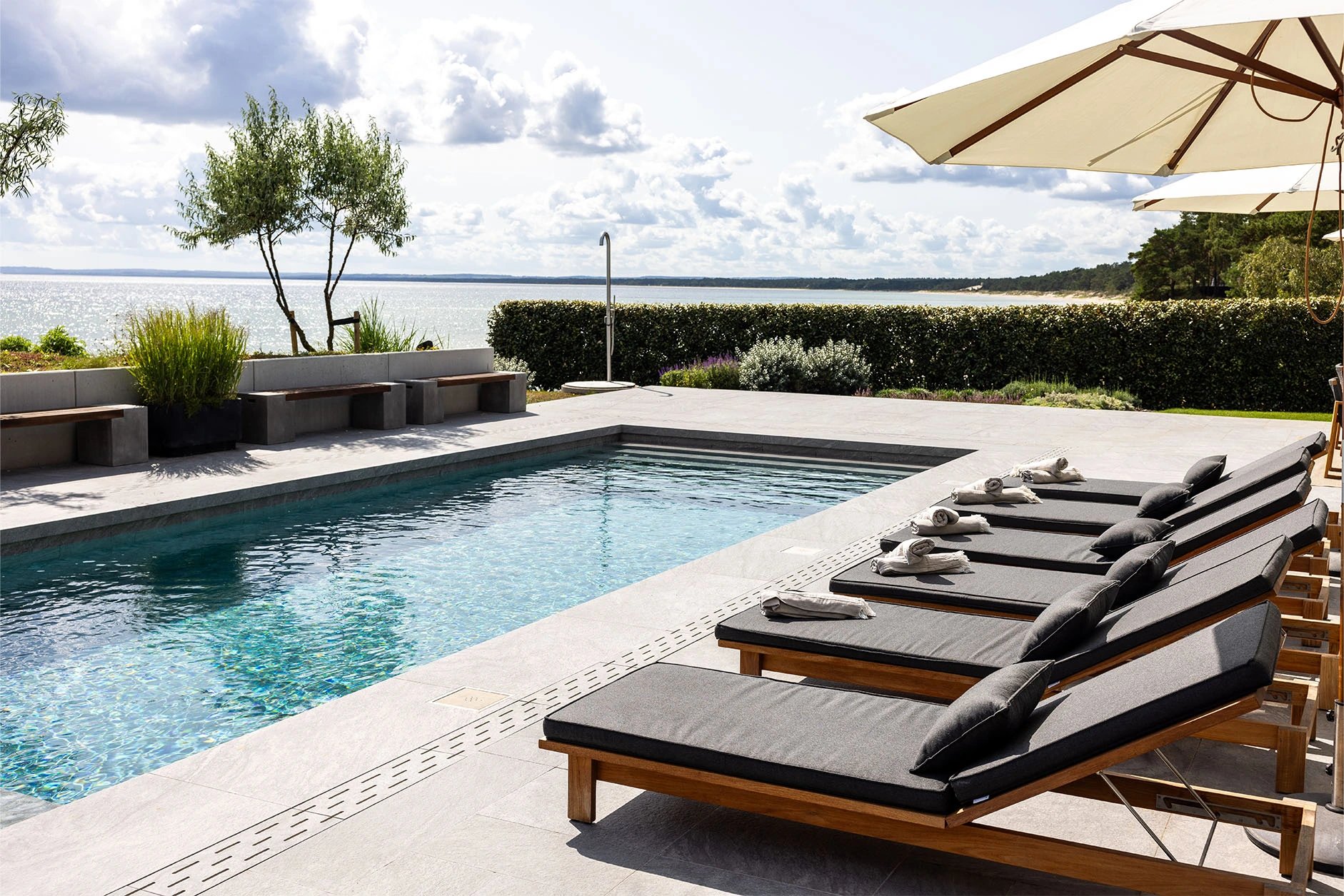 Pool and loungers overlooking the sea at Villa Sand