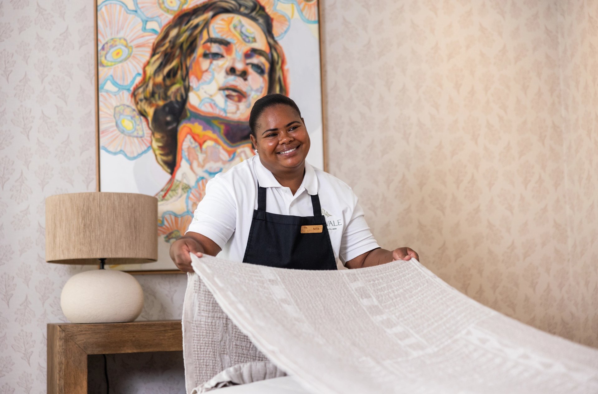 Housekeeper preparing a bedroom