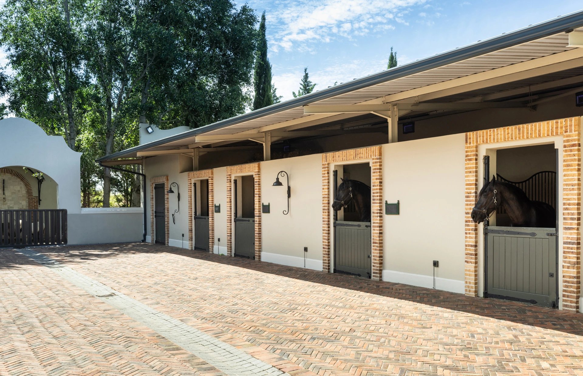 Oakvale Estate stables with horses looking out over the courtyard
