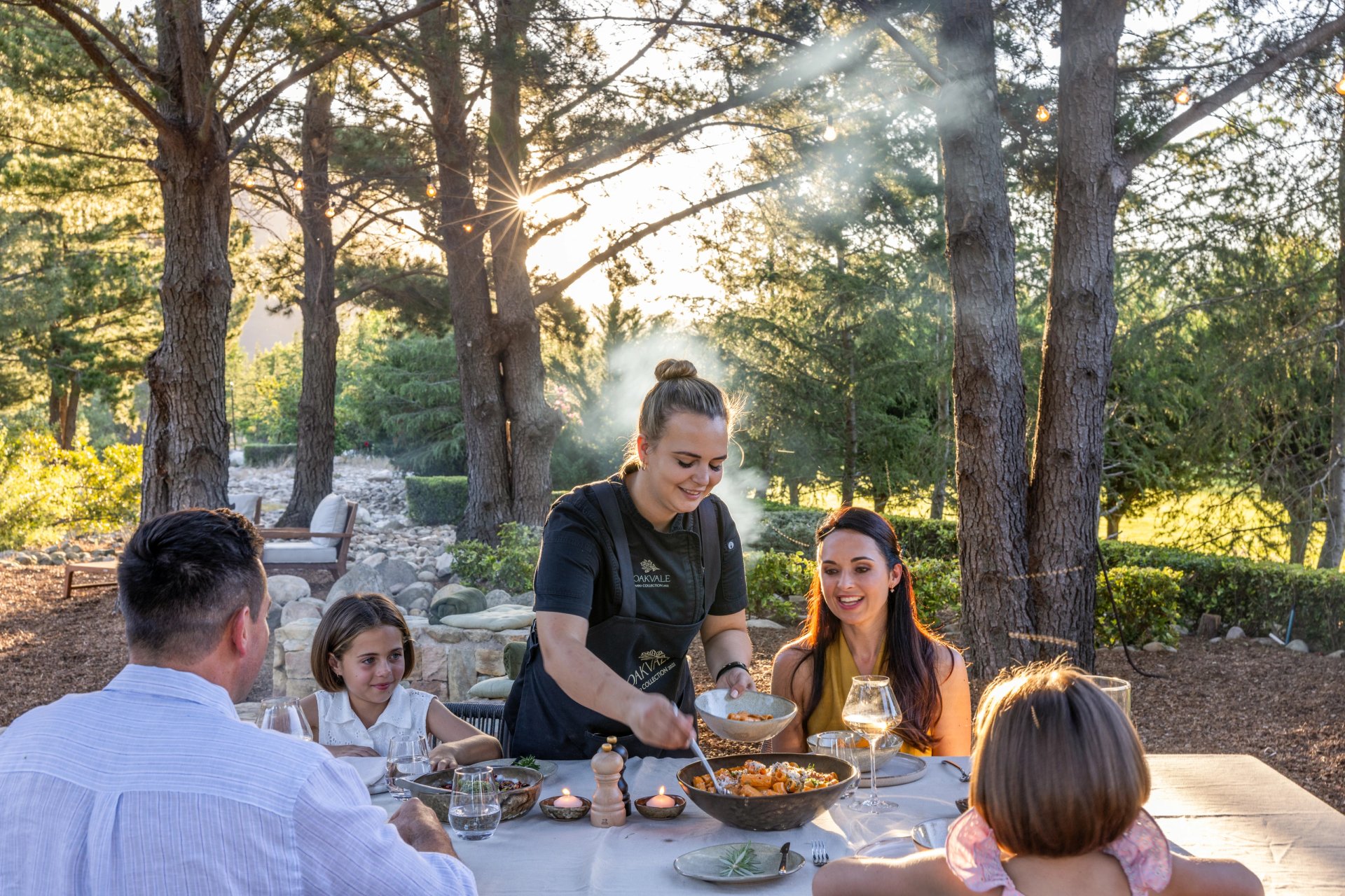 Chef serving an outdoor family meal