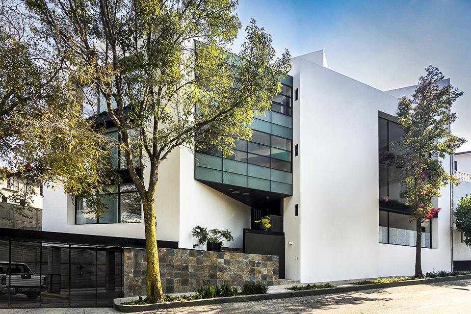 Edificio Tamaulipas 20 en la esquina, entre árboles