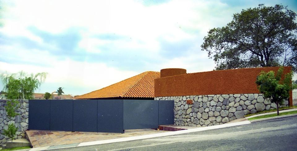Muro de piedra y cubierta de teja frente a la calle