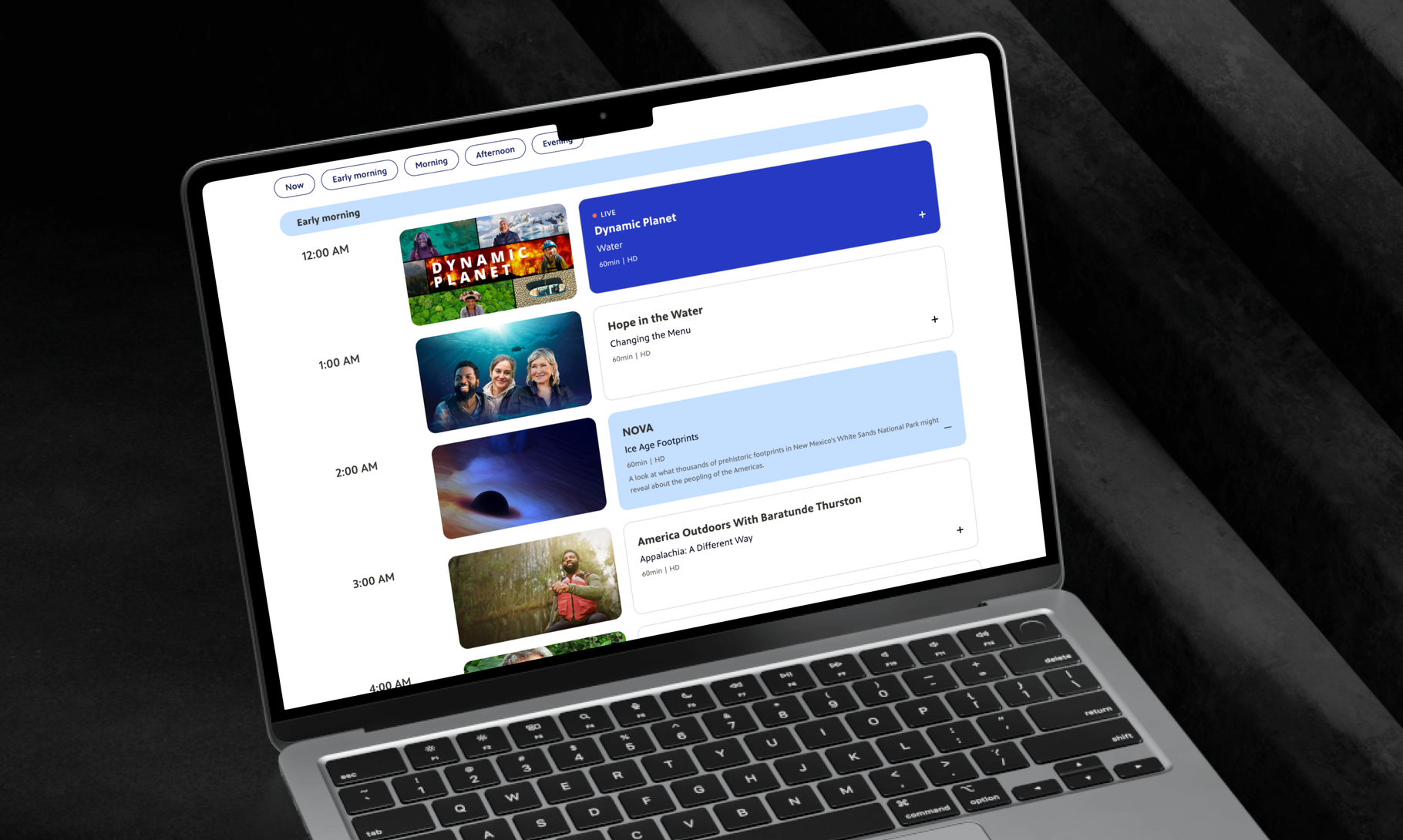 A MacBook displays a content scheduling interface with multiple video thumbnails and time slots arranged in a vertical timeline format.
