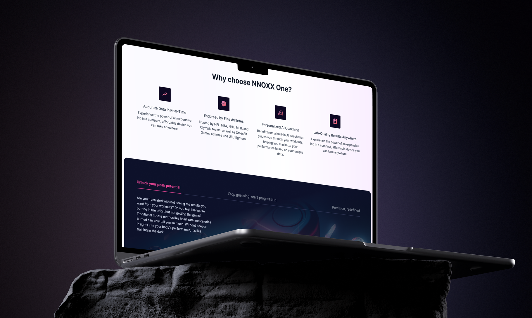 A laptop displaying the "Why choose NNOXX One?" webpage sits atop a dark textured surface against a shadowy background.